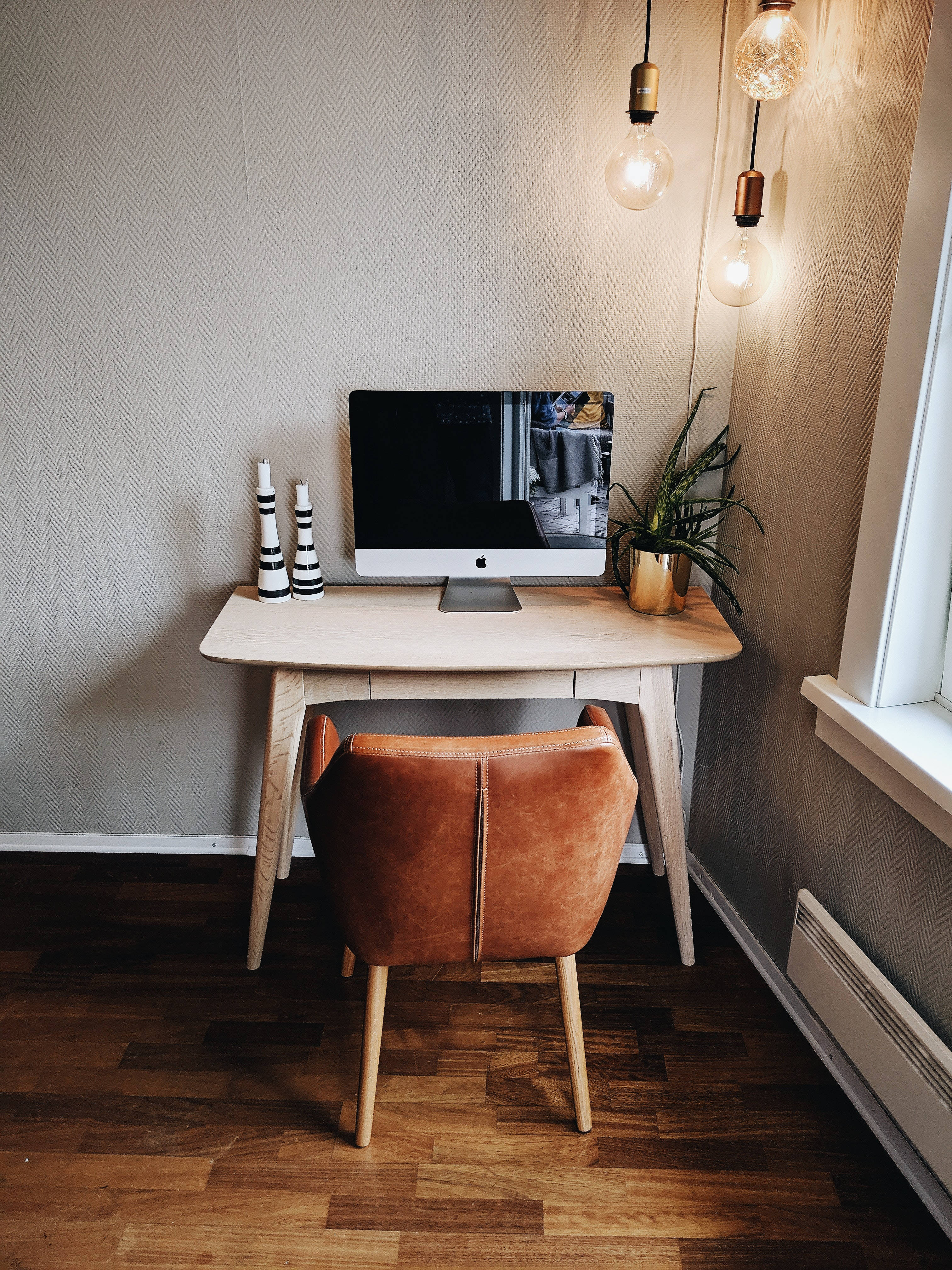 Sleek Aesthetic Mac setup, warm lights, wooden desk, 4K Phone Wallpaper