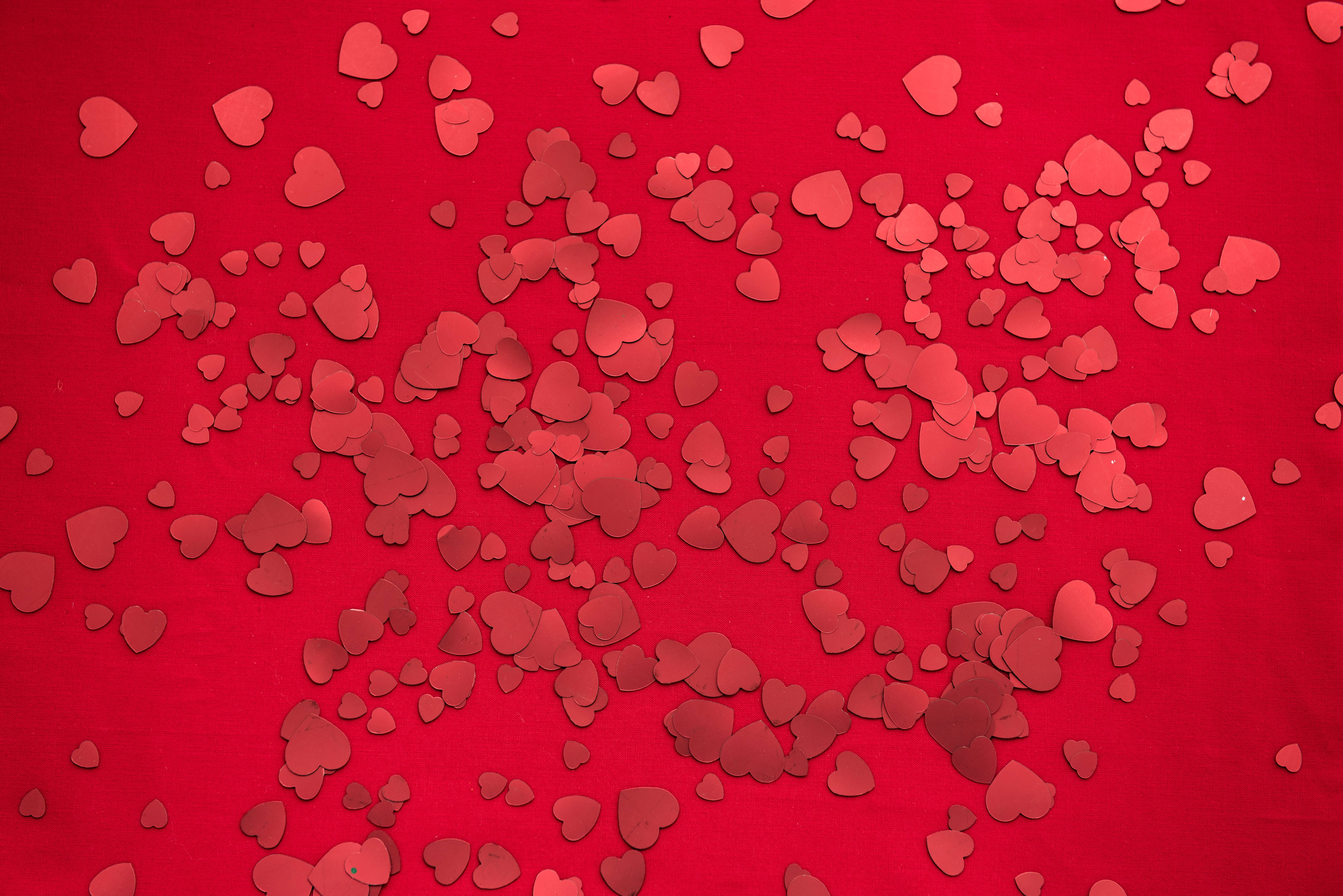 red hearts, vibrant red fabric surface, small red paper hearts, 5K Desktop Wallpaper