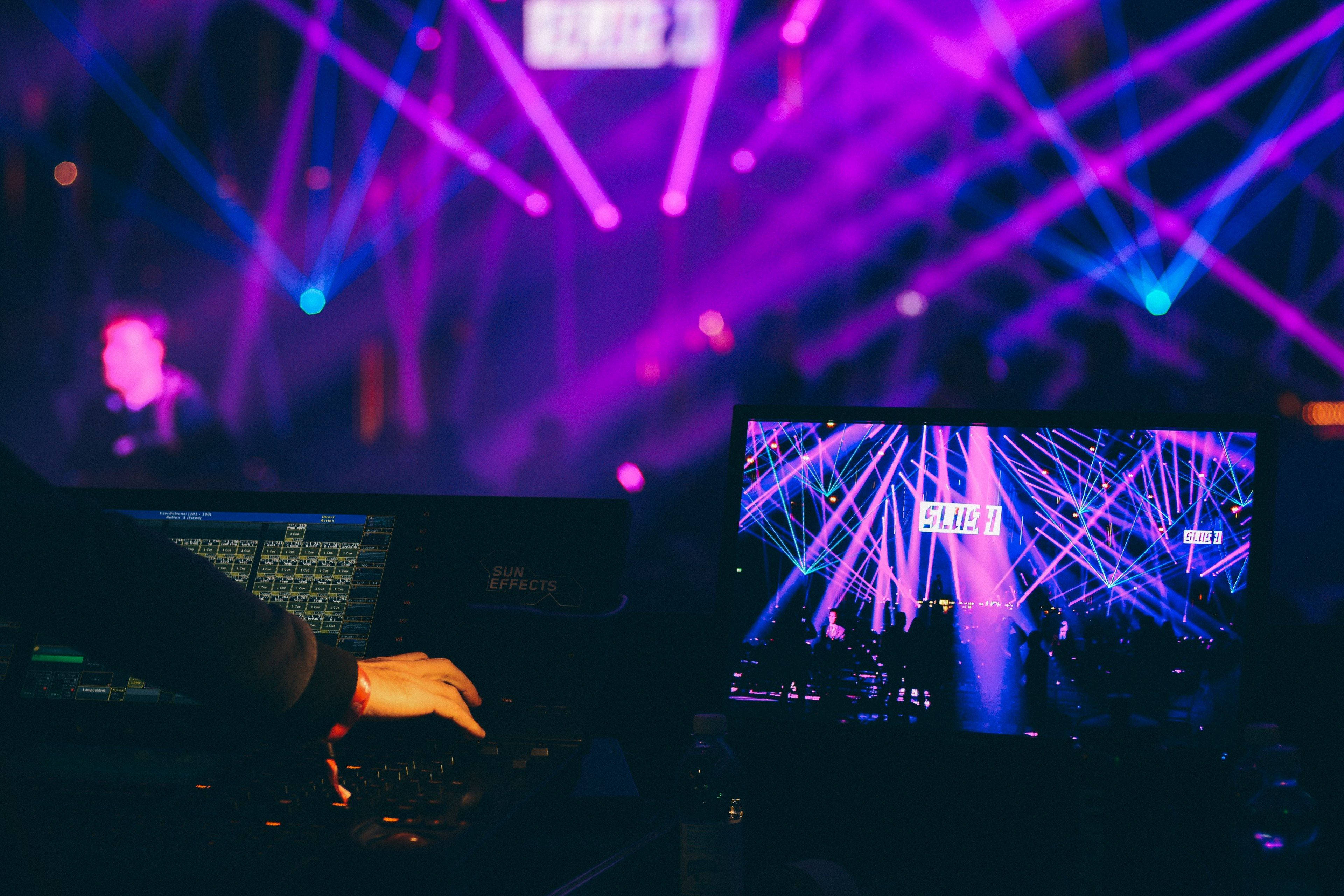 Nightclub DJ, vibrant purple and blue laser lights, laptop, 4K Desktop Wallpaper