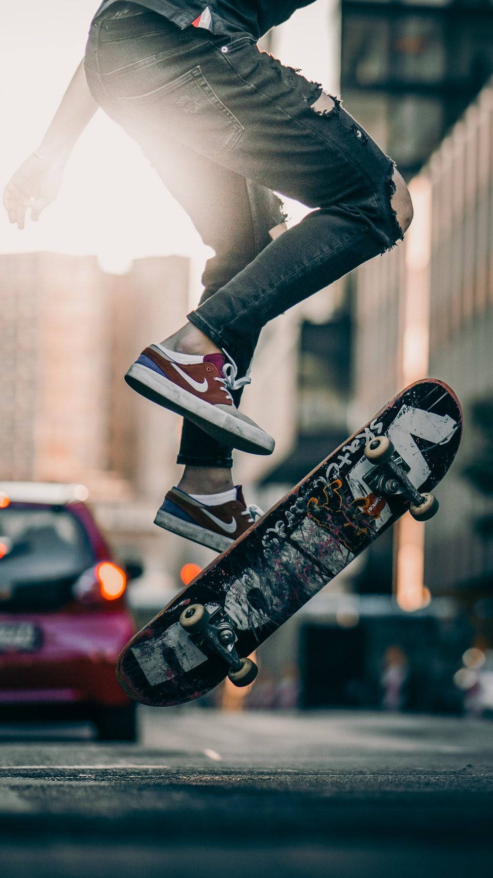 aesthetic skateboard, sunlit urban street, mid-air performing a trick, HD Phone Wallpaper
