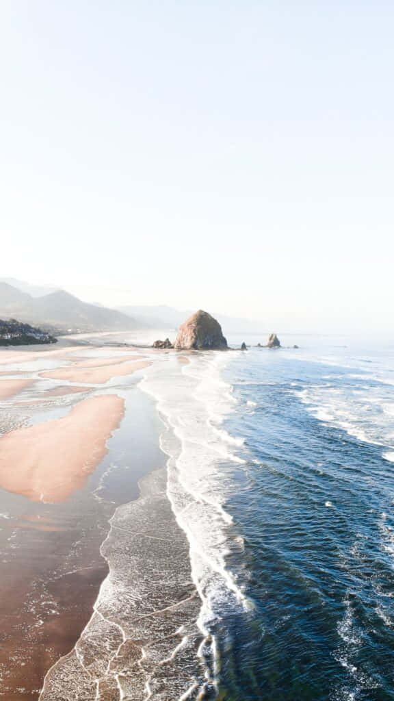 serene beach summer morning, pinkish sand beach, large sea stack, SD Phone Wallpaper
