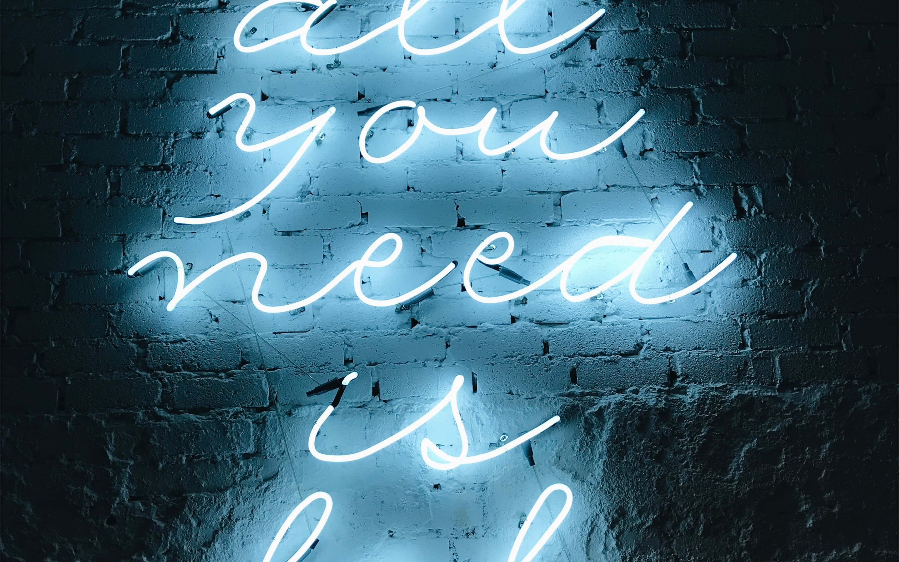 glowing blue neon sign, all you need is, dark textured brick wall, 2K Desktop Wallpaper