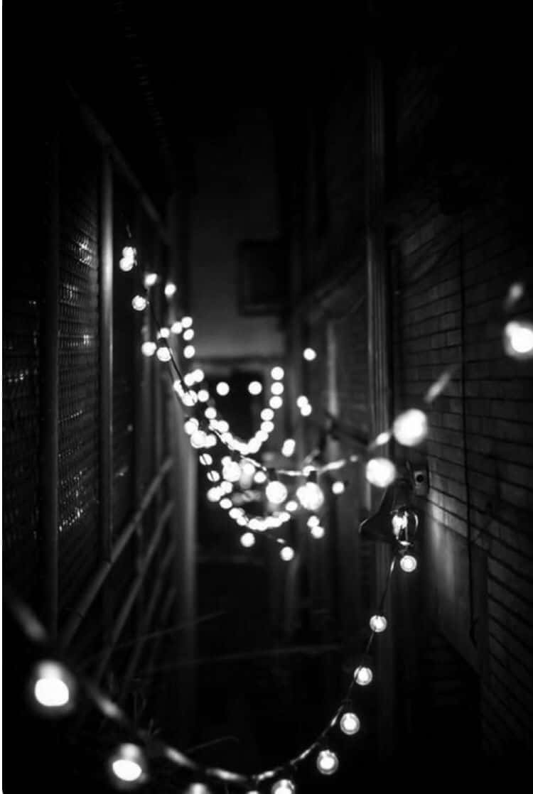 white iPhone, black accents, bokeh string lights, SD Phone Wallpaper