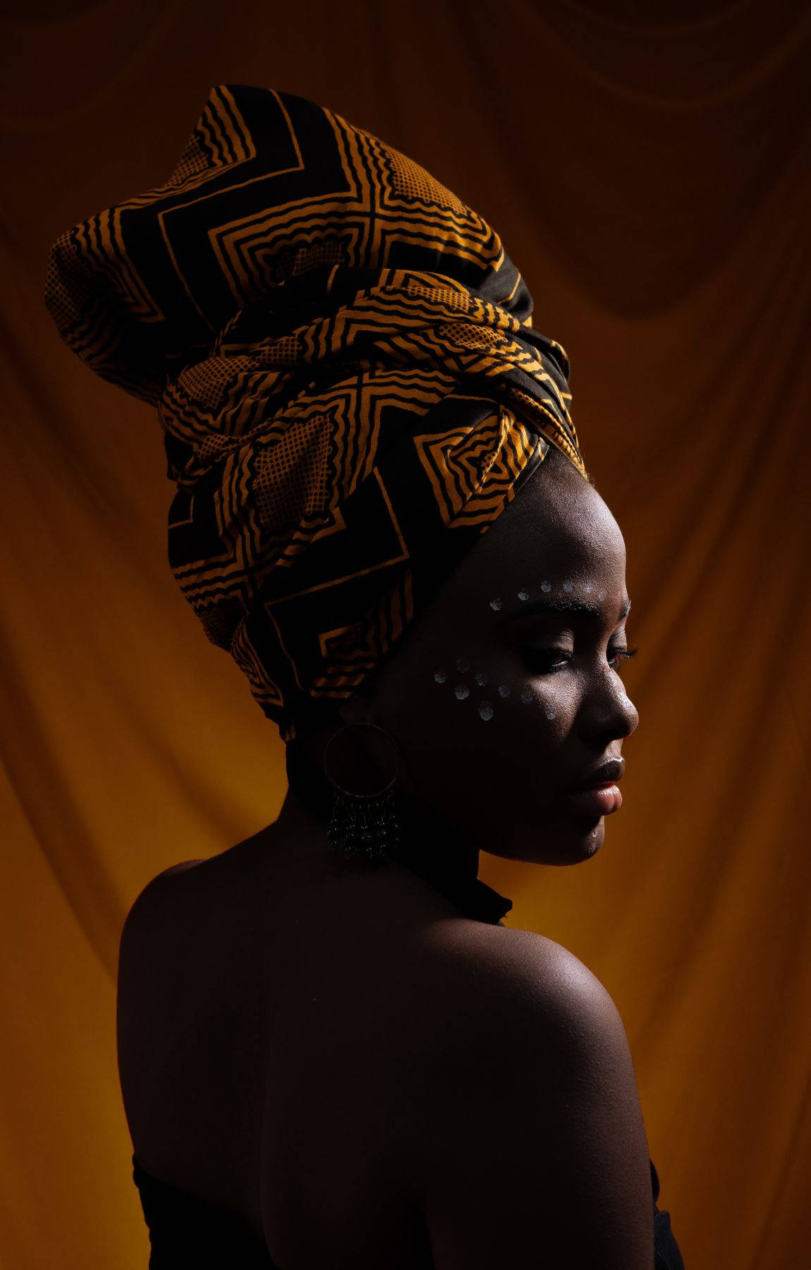 African Woman, black and gold patterned headwrap, warm draped backdrop, HD Phone Wallpaper