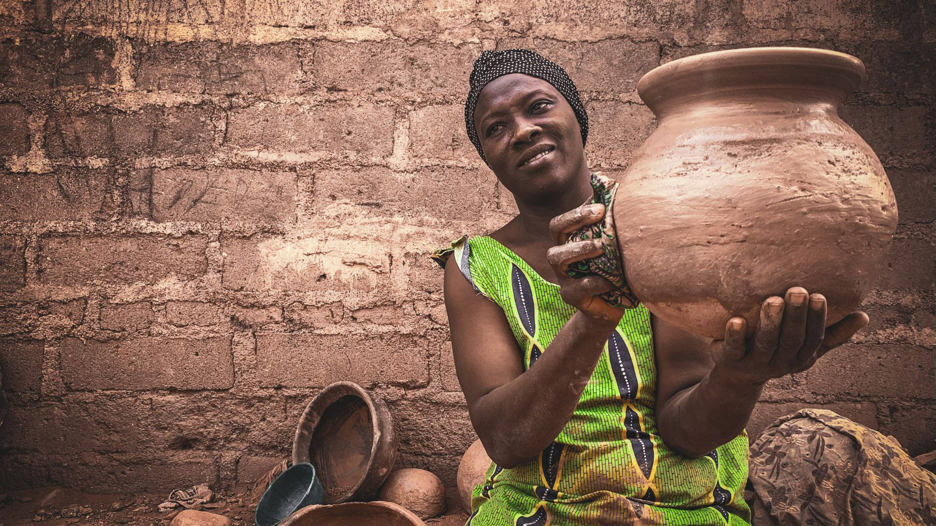 African Woman, vibrant green attire, large handmade clay pot, Full HD Desktop Wallpaper