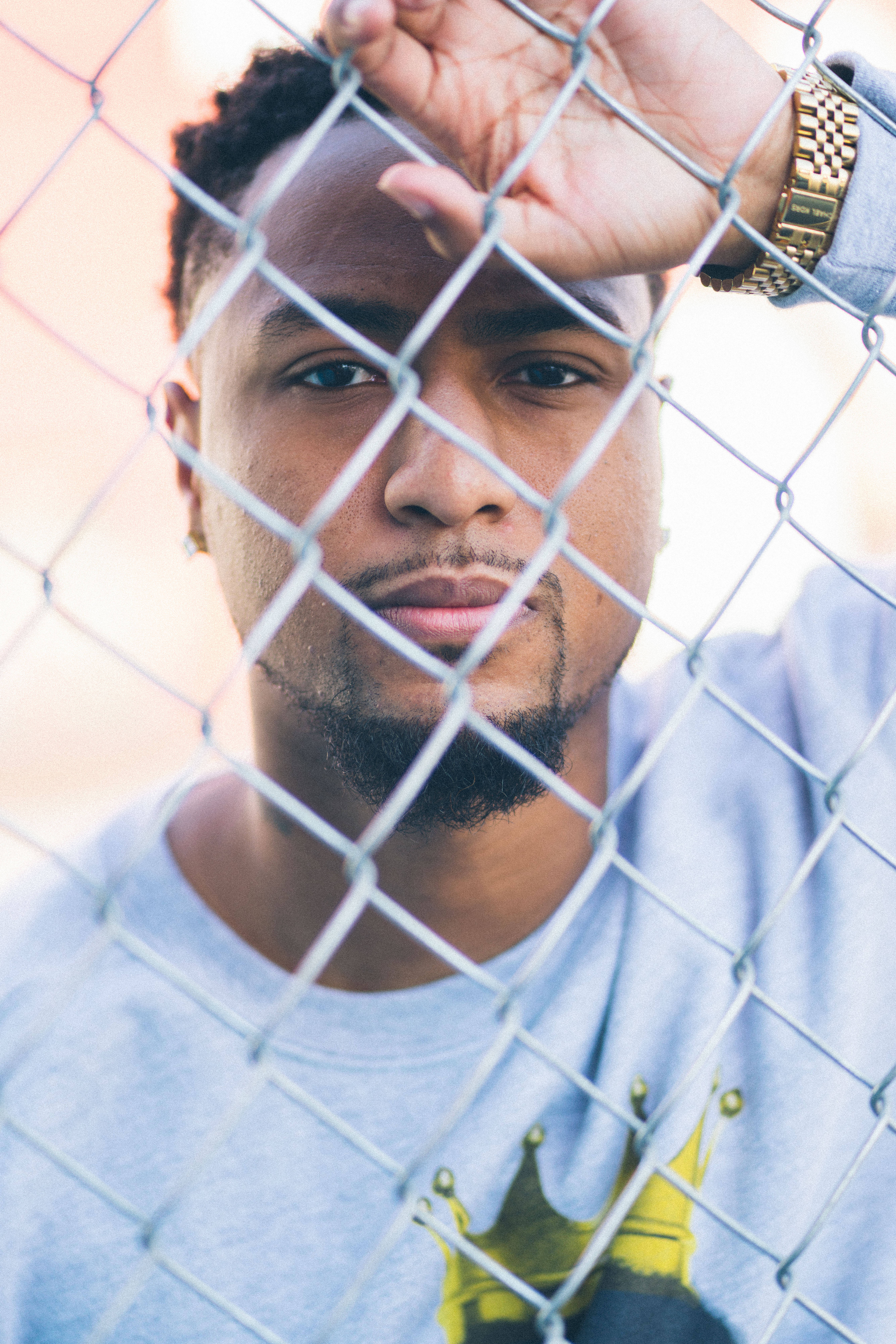 African man, chain-link fence, gold watch, 5K Phone Wallpaper