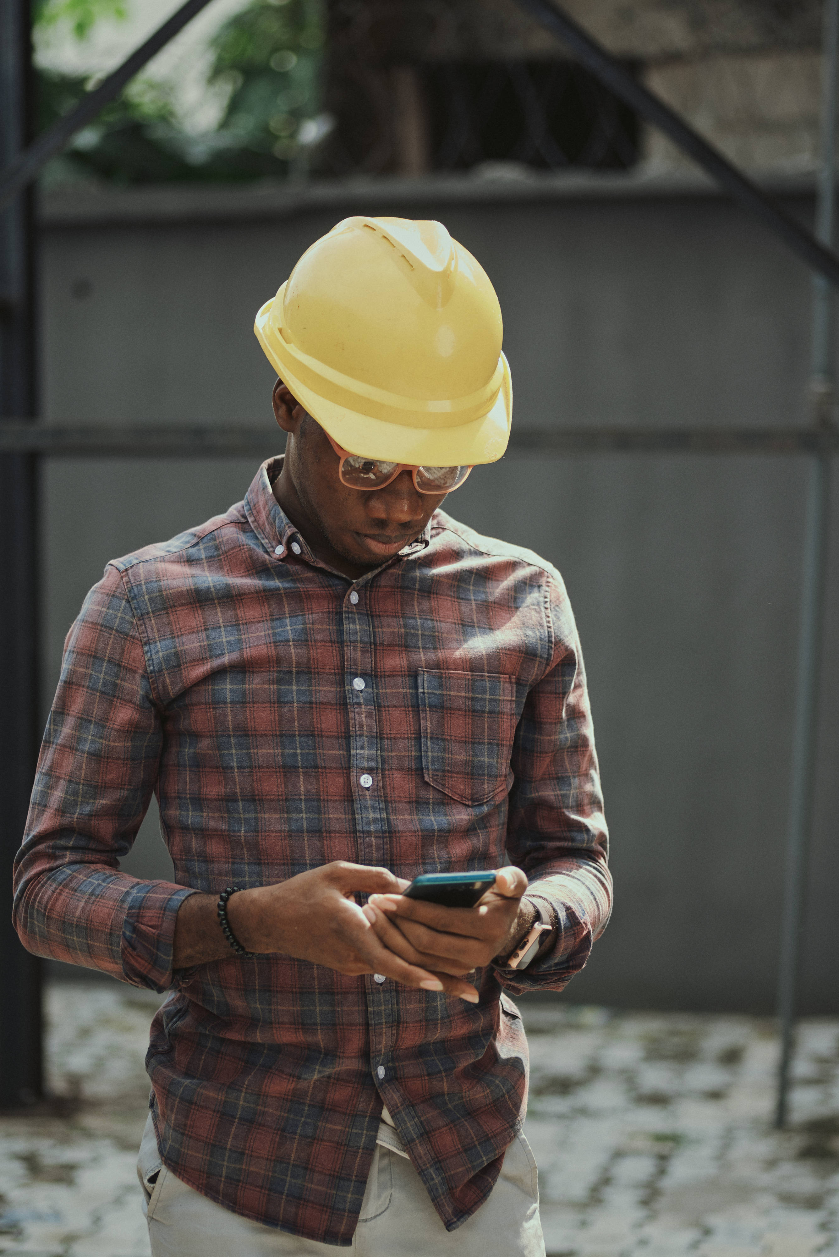 African man, plaid shirt, yellow hard hat, 4K Phone Wallpaper
