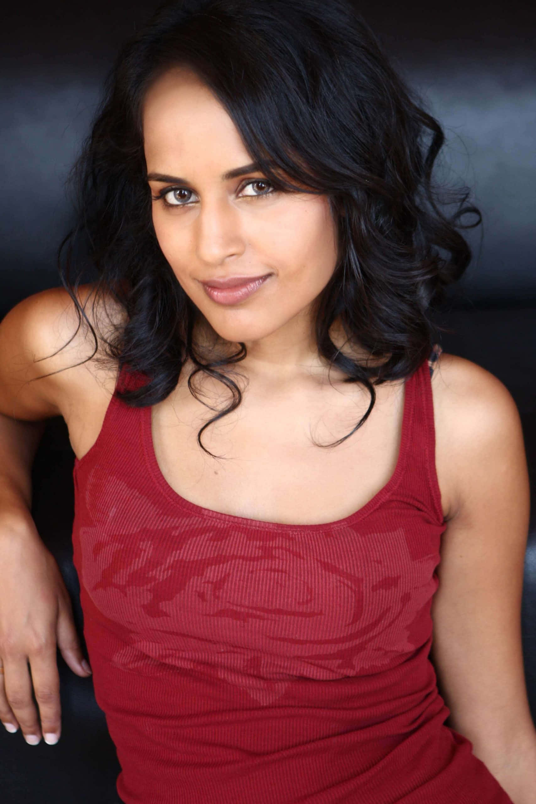 Agam Darshi, dark wavy hair, red ribbed tank top, 2K Phone Wallpaper
