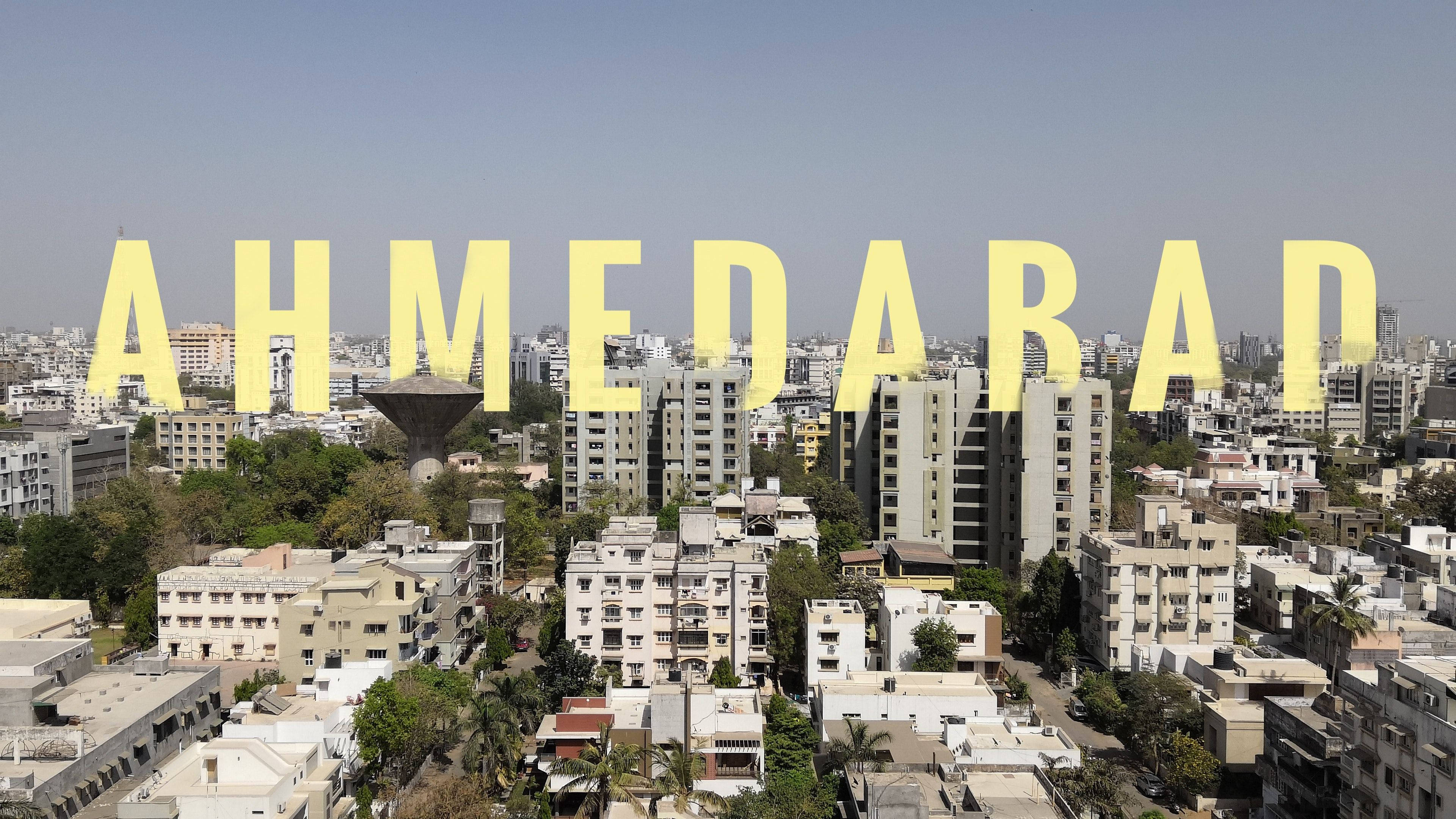 Ahmedabad, yellow text, dense urban buildings, 4K Desktop Wallpaper