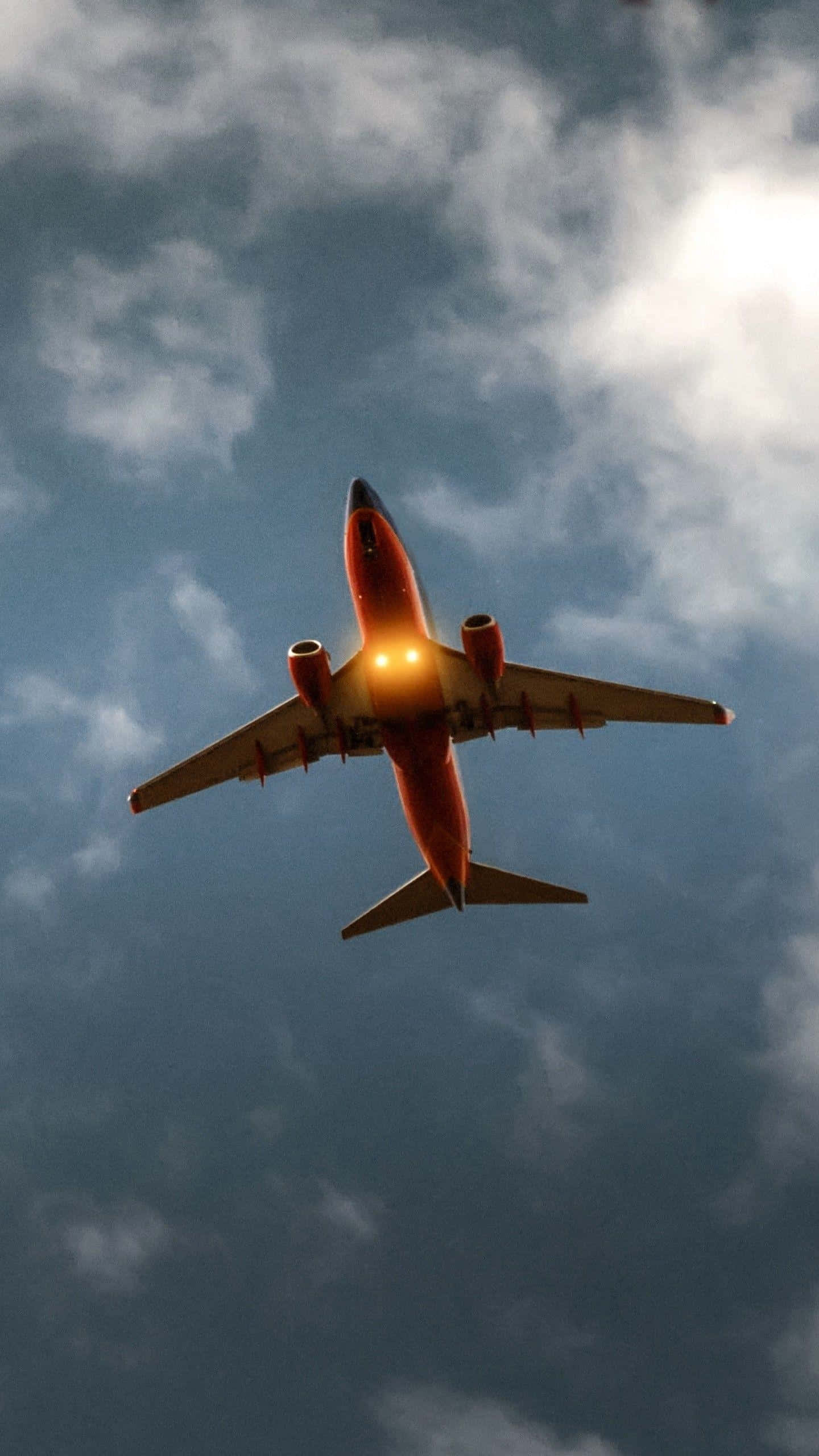 red airplane, cloudy sky, glowing navigation lights, 2K Phone Wallpaper