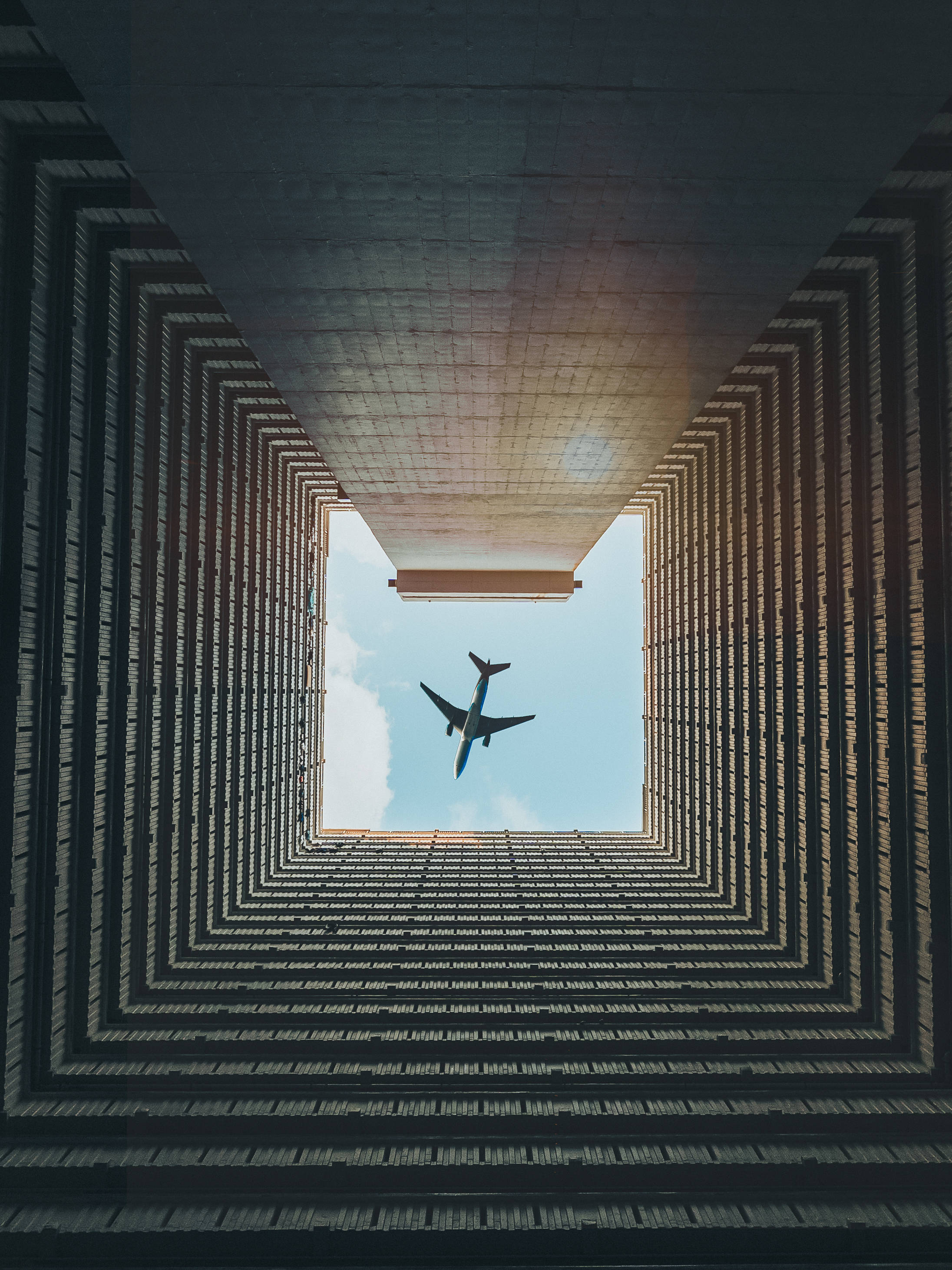 Airplane iPhone, blue sky, geometric concrete structure, 2K Phone Wallpaper