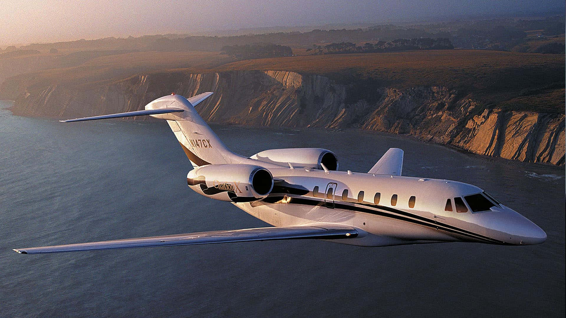 private jet, coastal cliffs, golden hour, Full HD Desktop Wallpaper