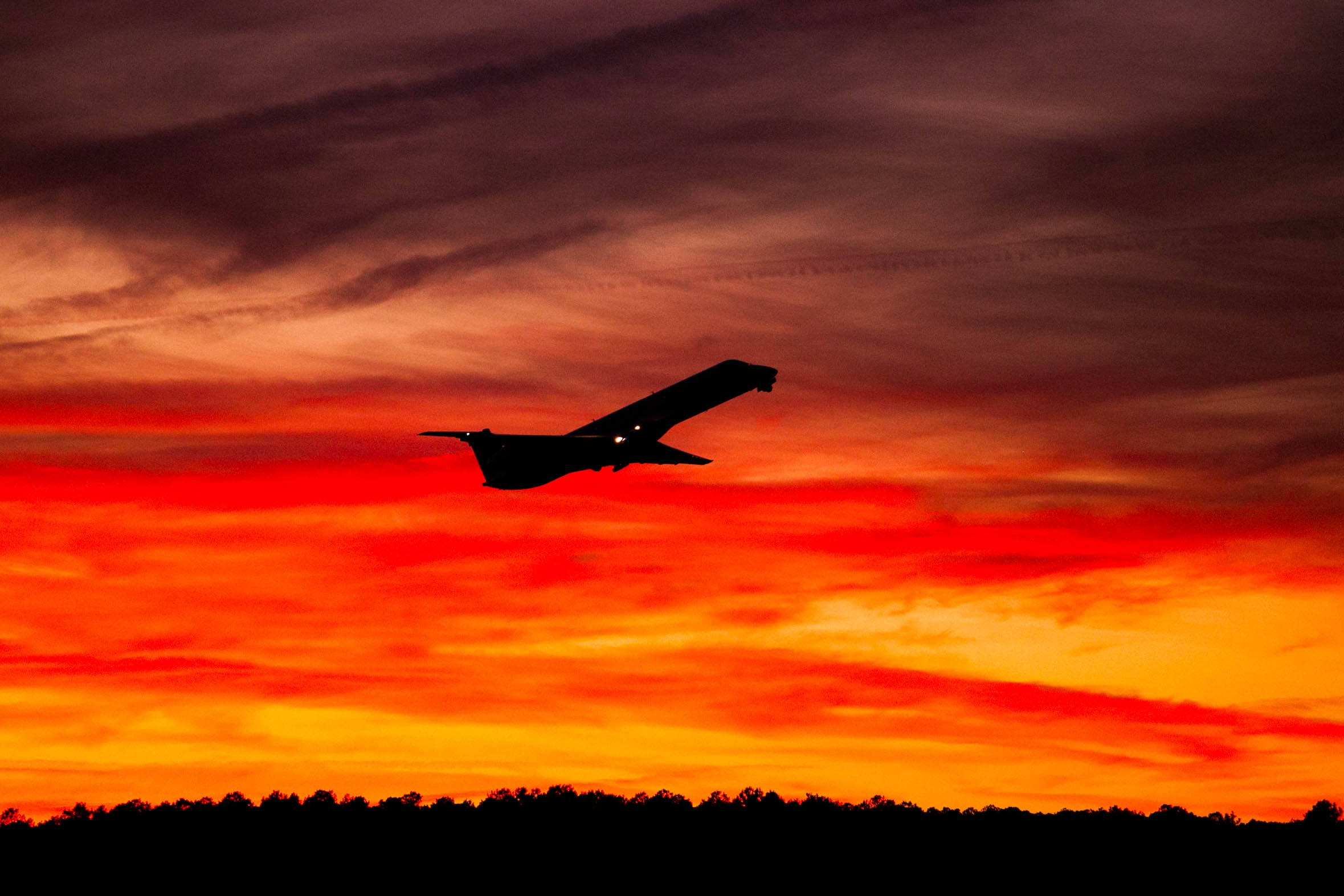 black airplane, sleek airplane silhouette, fiery orange and red sunset sky, Full HD Desktop Wallpaper