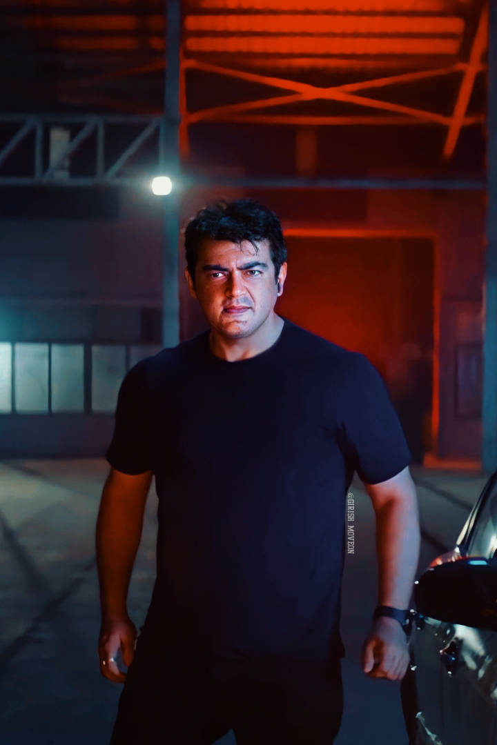 Ajith HD, black t-shirt, dimly lit industrial garage, SD Phone Wallpaper