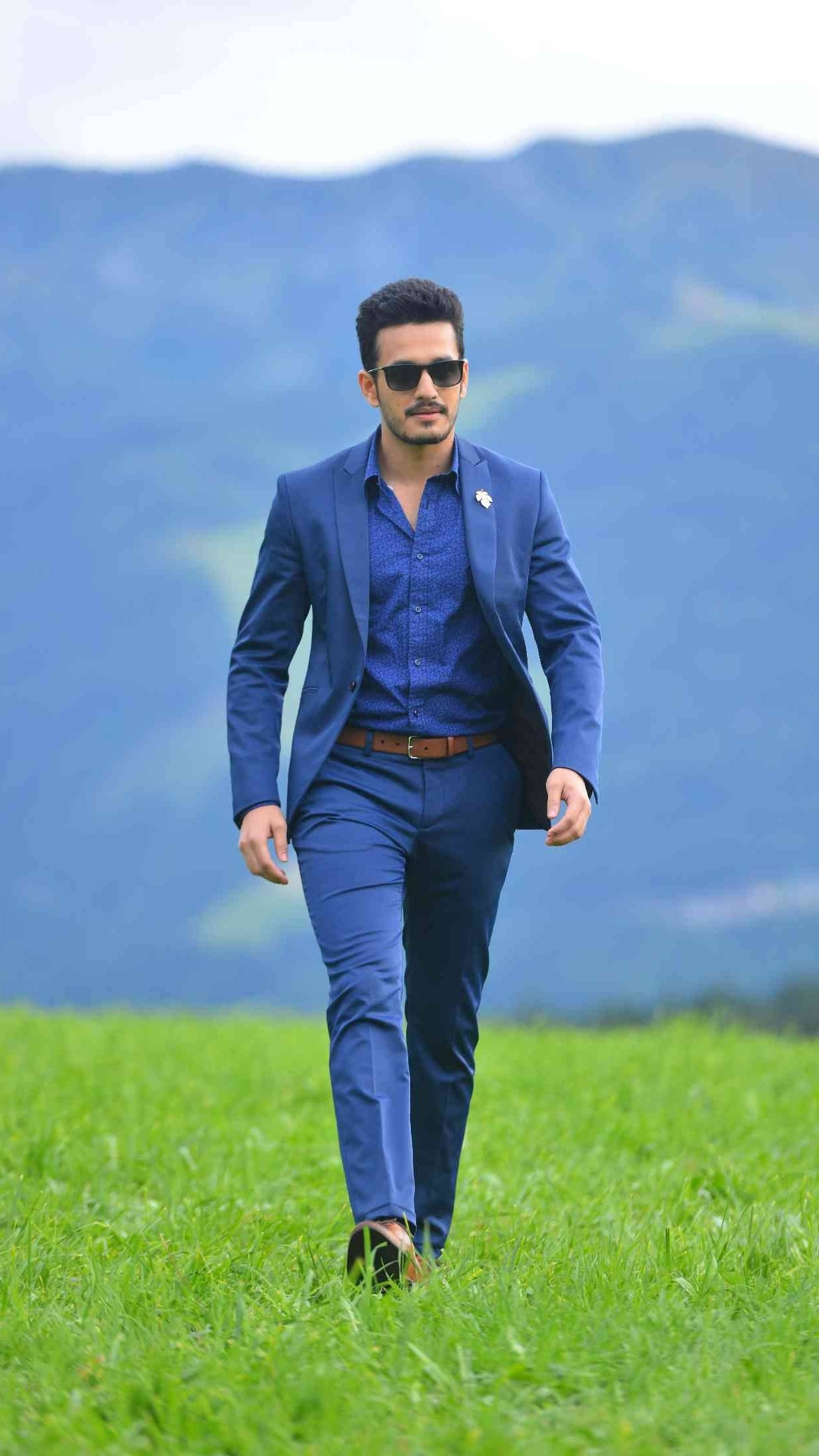 Akhil Akkineni, blue suit, vibrant green field, Full HD Phone Wallpaper