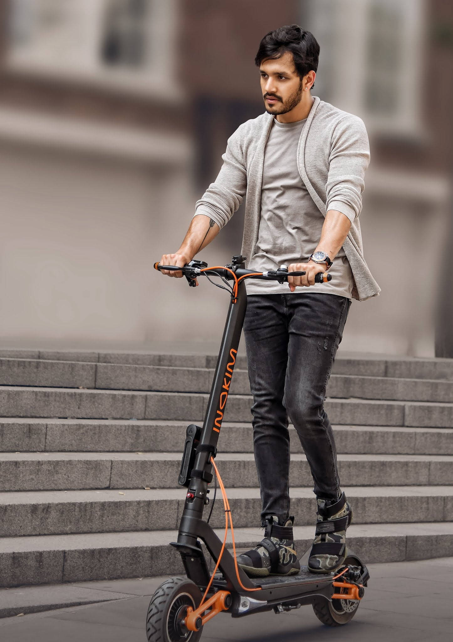 Akhil Akkineni, black and orange electric scooter, urban stone steps, Full HD Phone Wallpaper