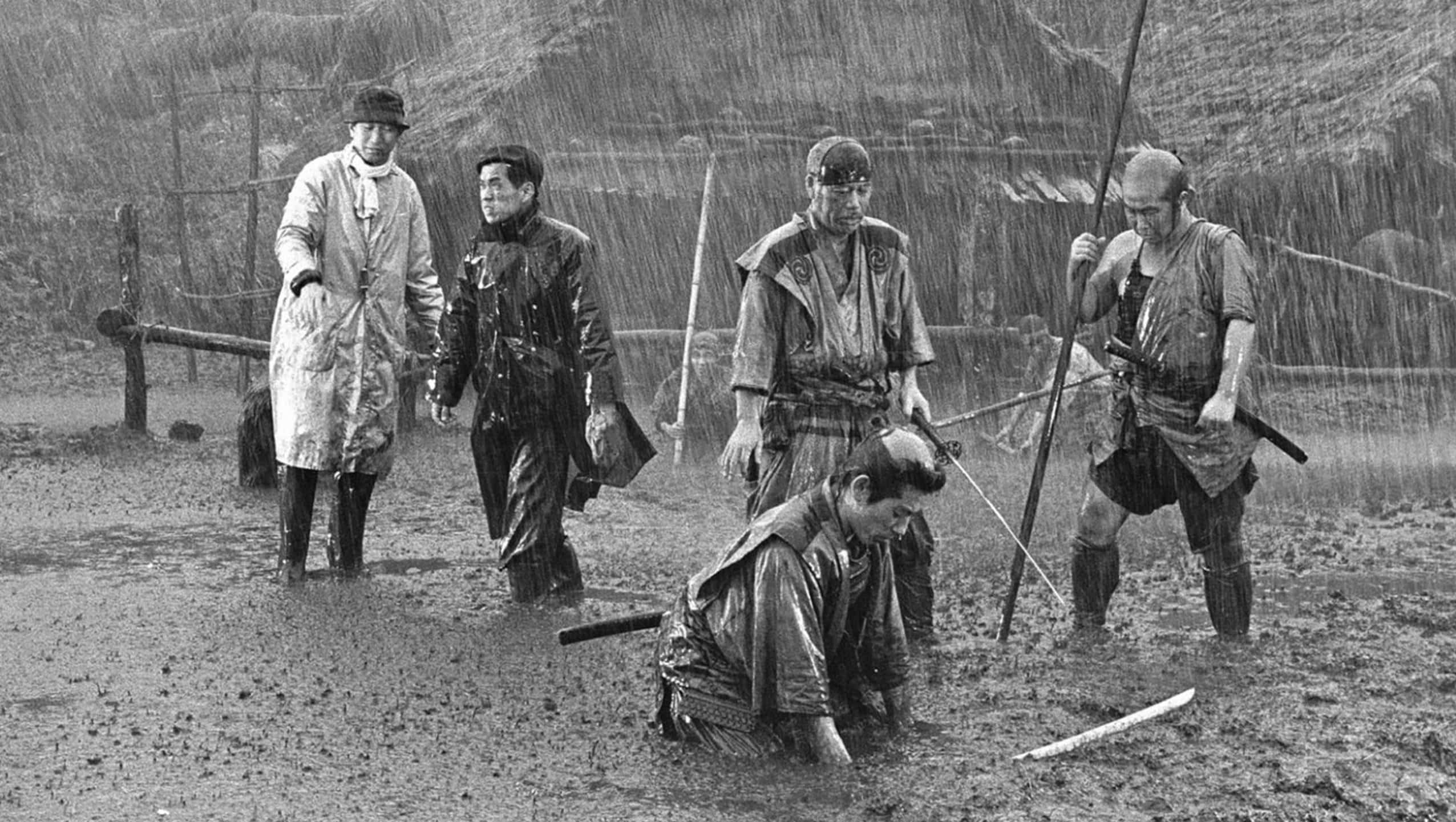 Akira Kurosawa, rain-soaked traditional attire, muddy terrain, Full HD Desktop Wallpaper