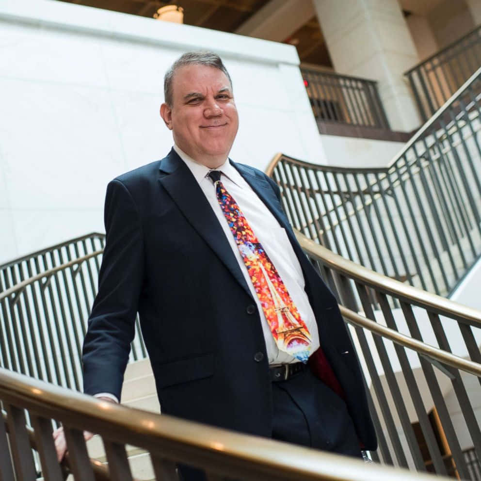 Alan Grayson, dark suit, vibrant Paris-themed tie, SD Desktop Wallpaper