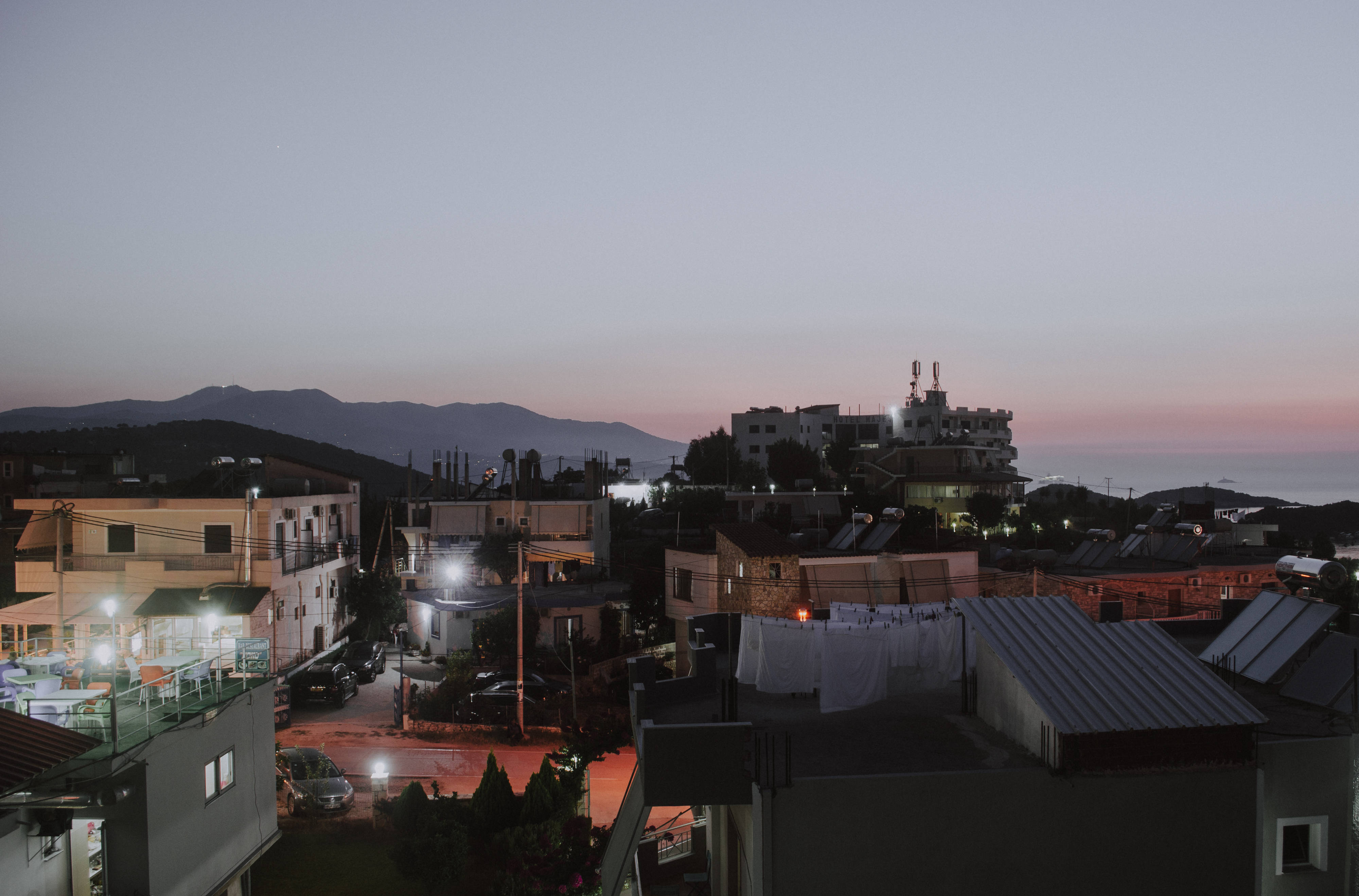 Albania, twilight coastal town, warm streetlights, 4K Desktop Wallpaper