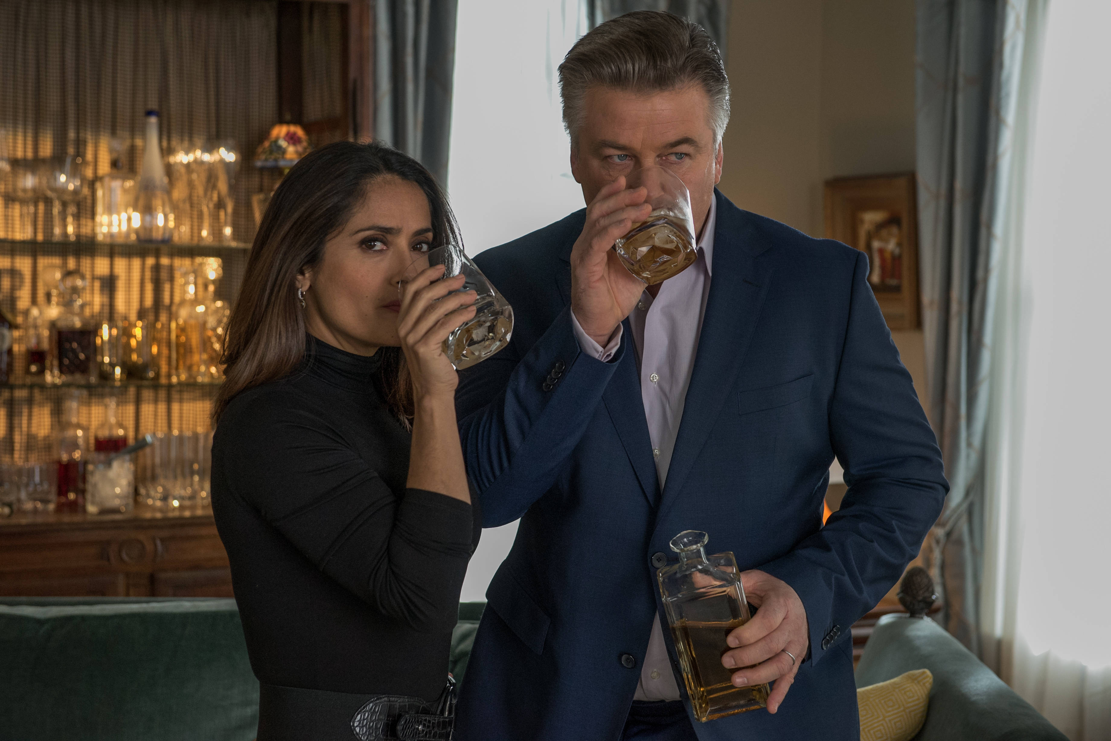 Alec Baldwin, whiskey, warmly lit living room, 2K Desktop Wallpaper