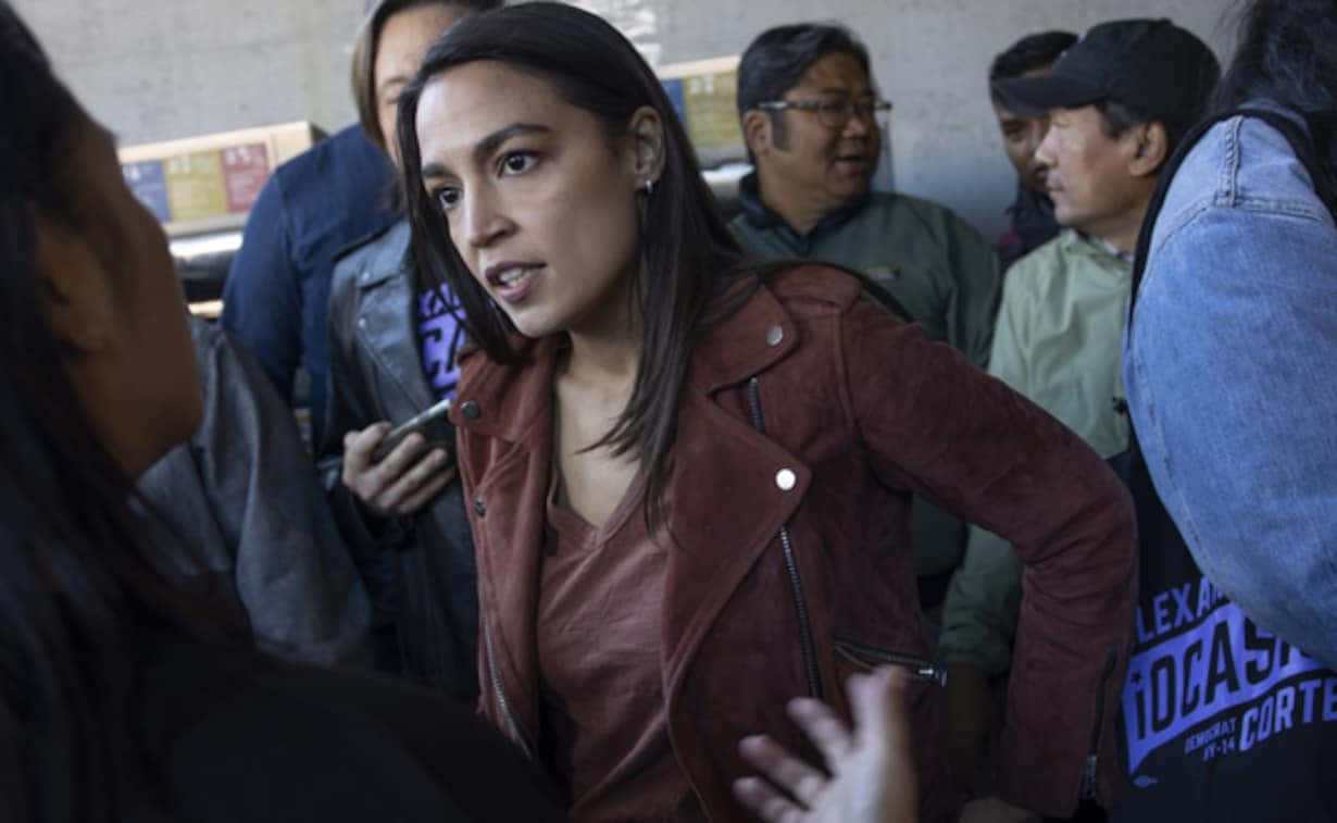 Alexandria Ocasio-Cortez, red leather jacket, crowded indoor setting, SD Desktop Wallpaper