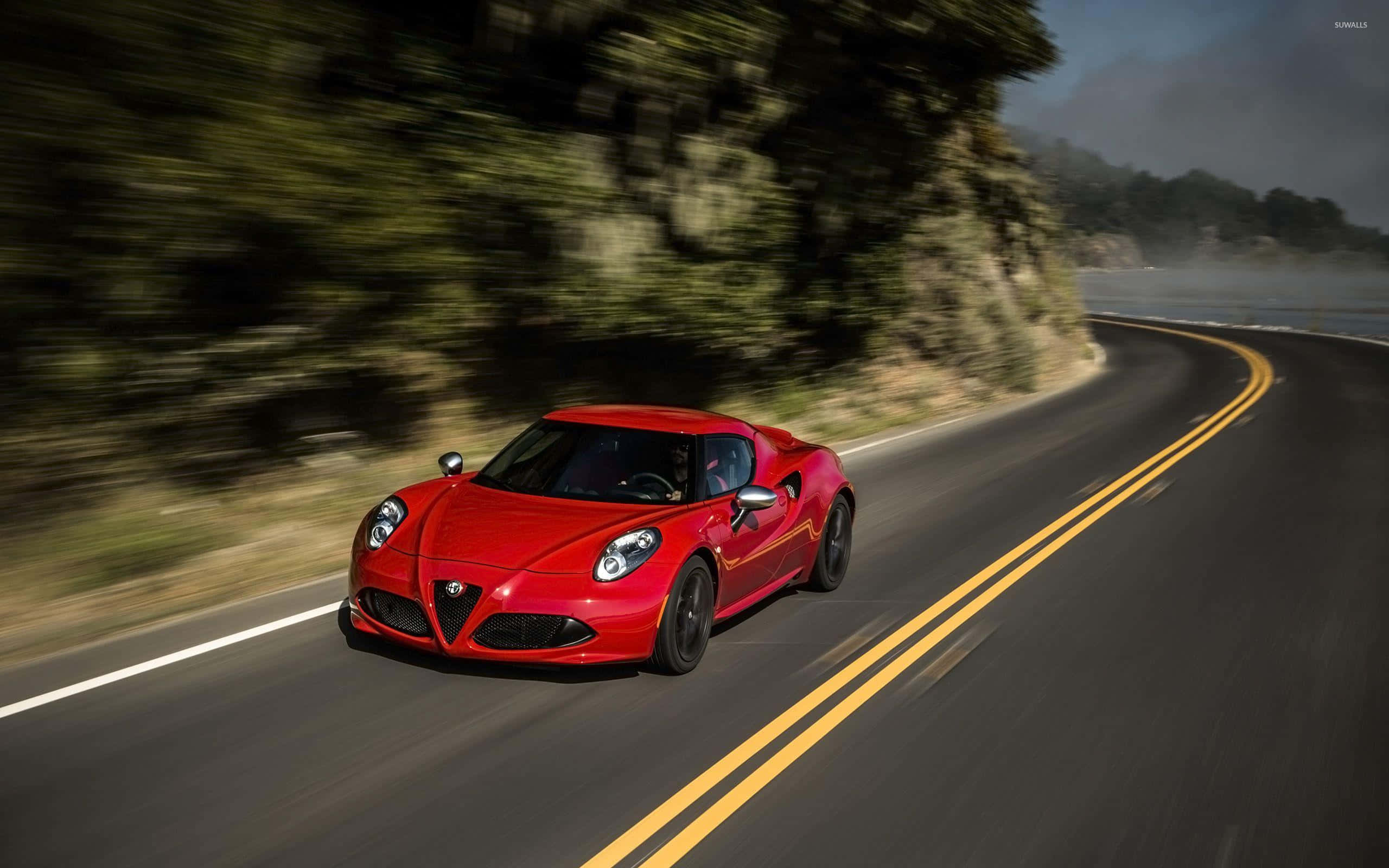 Alfa Romeo 4C, vibrant red, winding coastal road, 2K Desktop Wallpaper