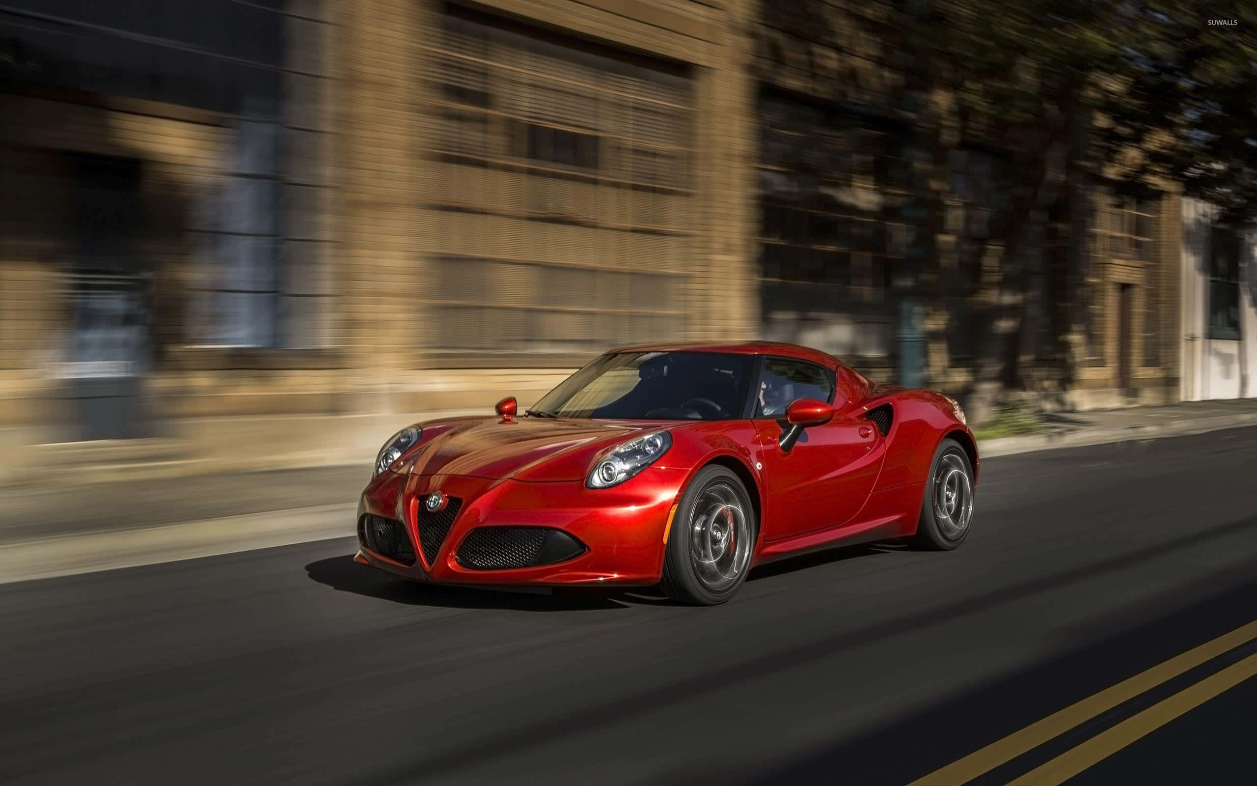 Alfa Romeo 4C, vibrant red, sunlit urban street, 2K Desktop Wallpaper