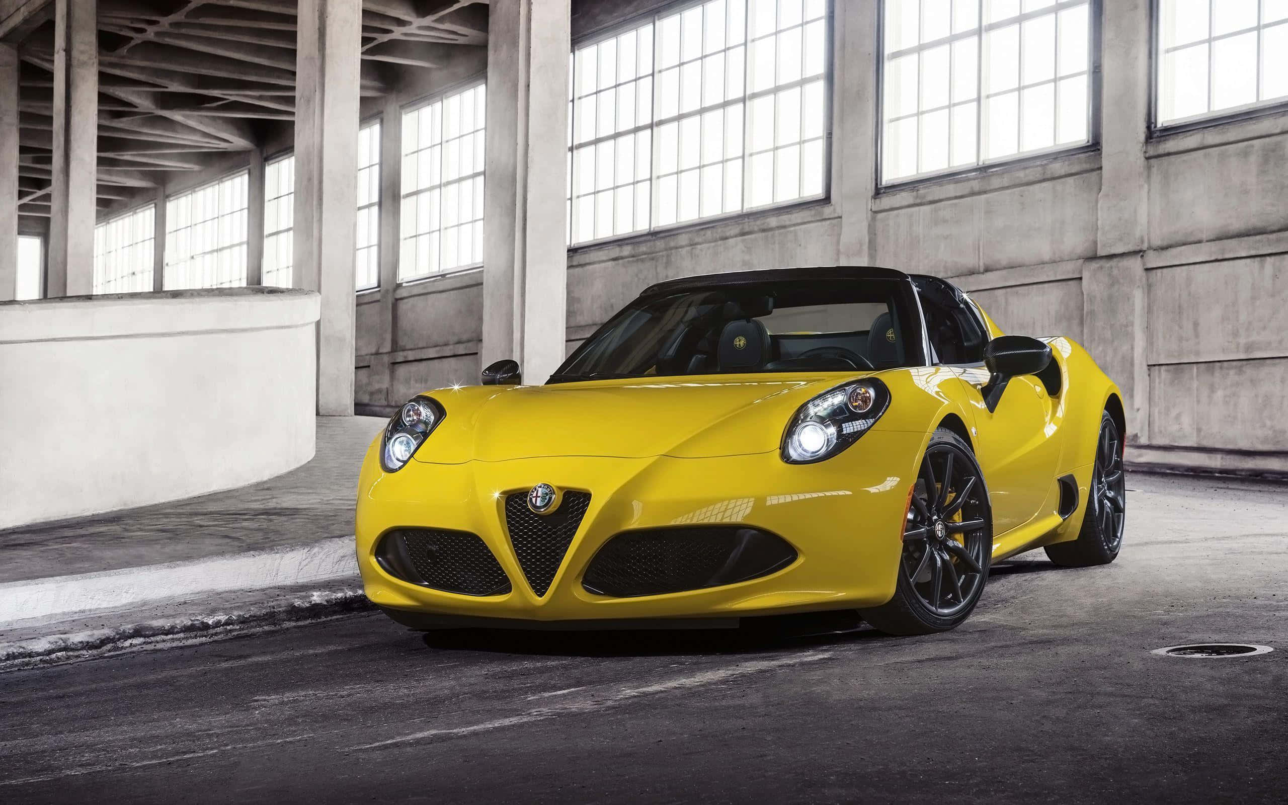 Alfa Romeo 4C, vibrant yellow, concrete warehouse, 2K Desktop Wallpaper