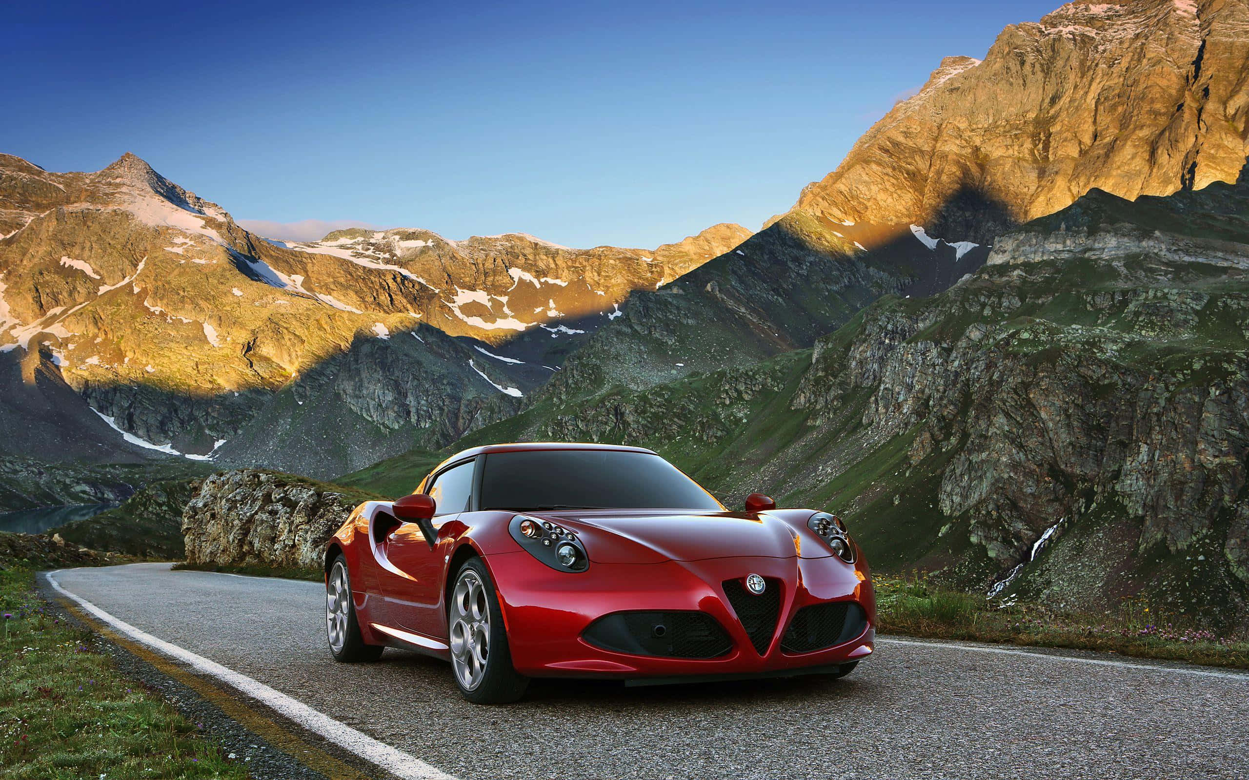 Alfa Romeo 4C, vibrant red, winding mountain road, 2K Desktop Wallpaper