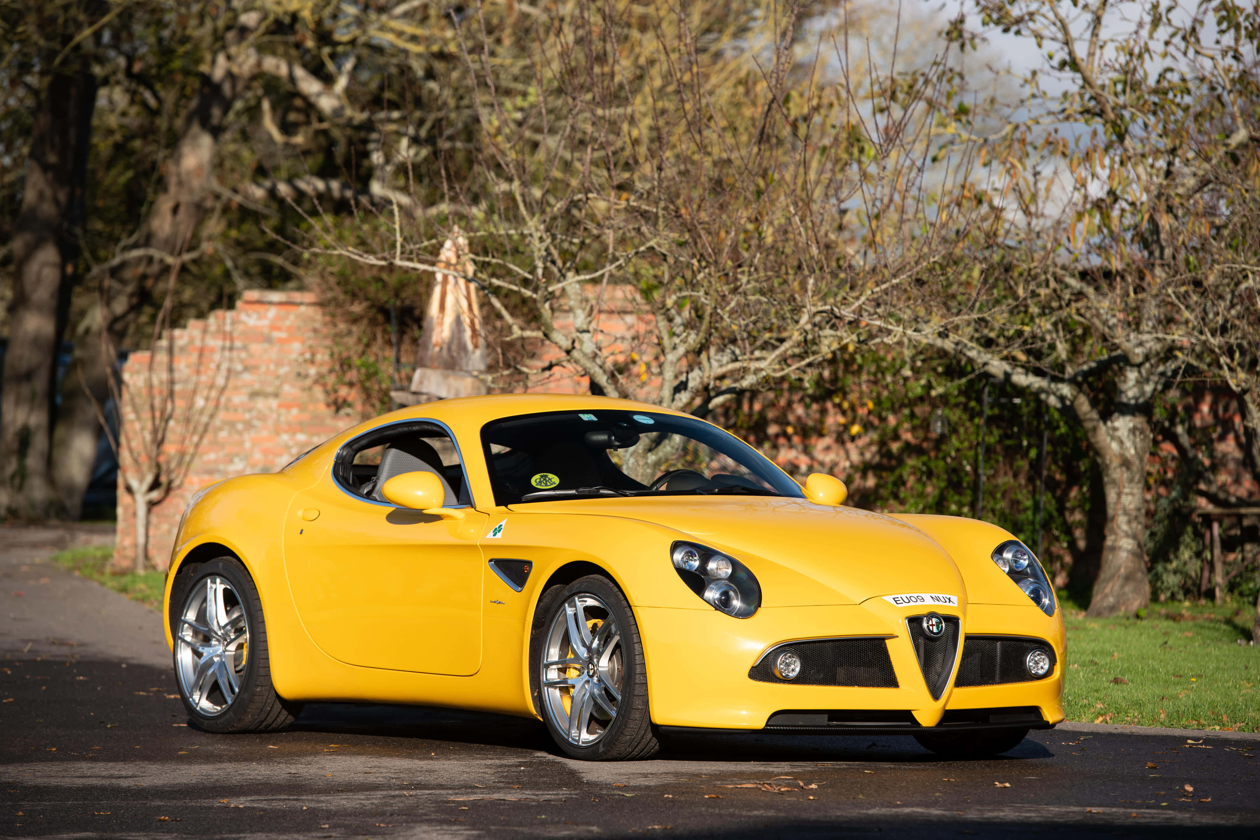 Alfa Romeo 8C Competizione, vibrant yellow, tree-lined road, 4K Desktop Wallpaper