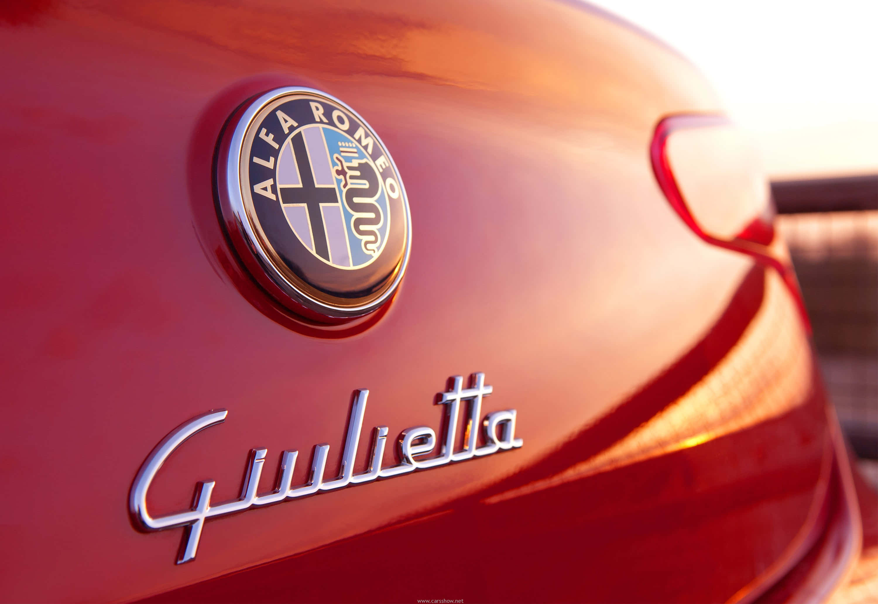 Alfa Romeo Giulietta, glossy red, golden sunset light, 2K Desktop Wallpaper