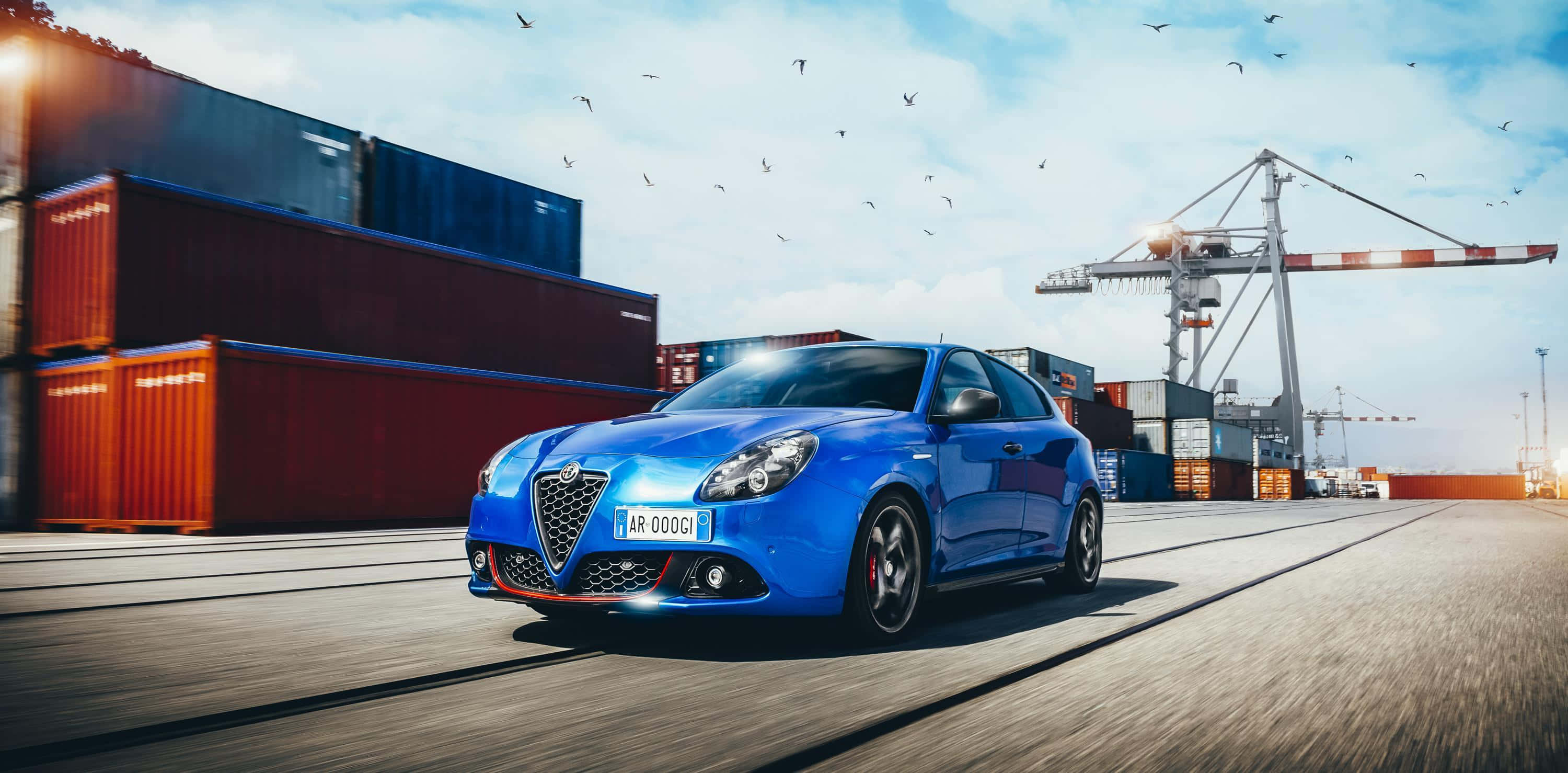 Alfa Romeo Giulietta, vibrant blue, sunlit port, 2K Desktop Wallpaper