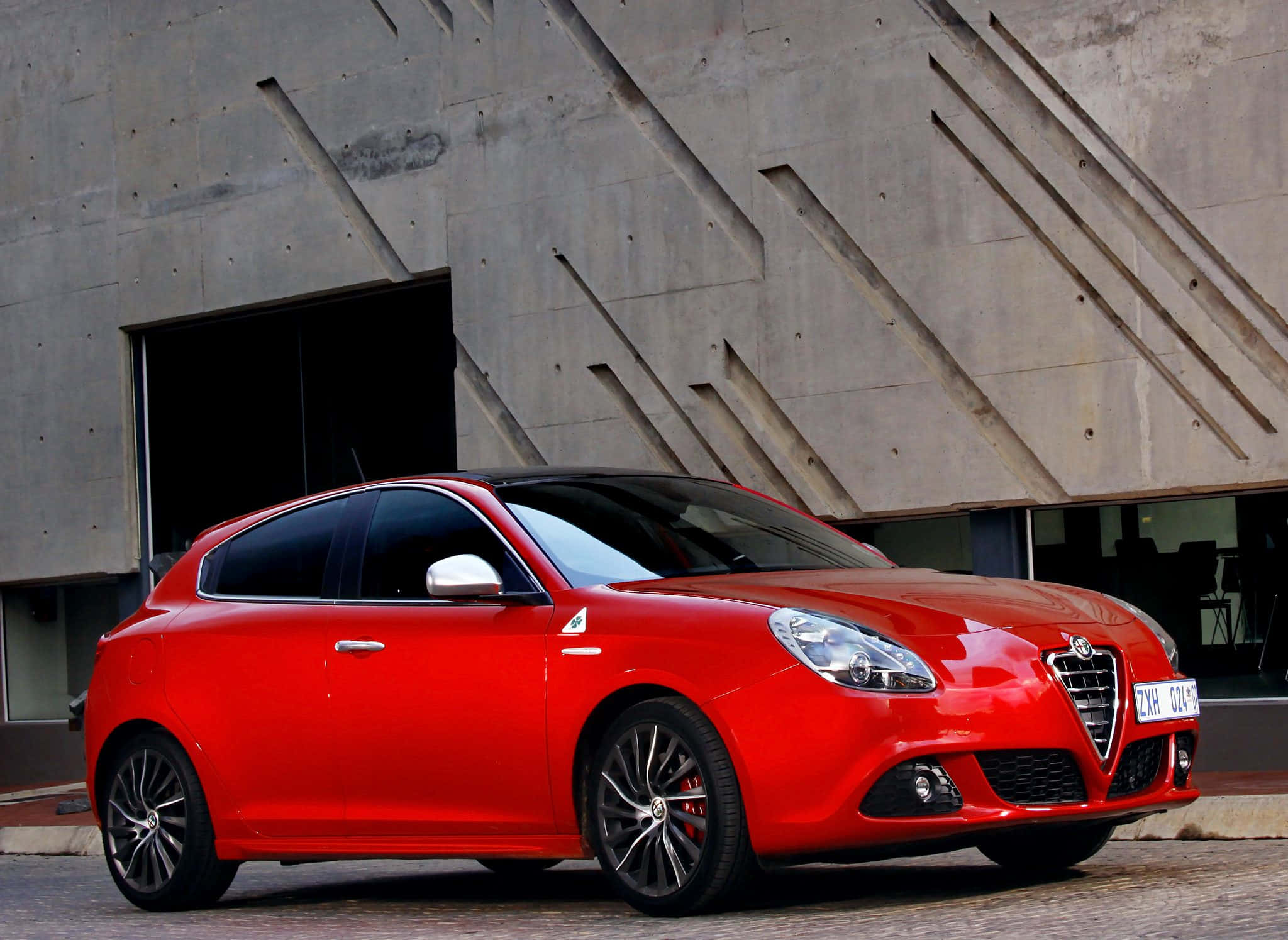 Alfa Romeo Giulietta, vibrant red, modern concrete building, Full HD Desktop Wallpaper