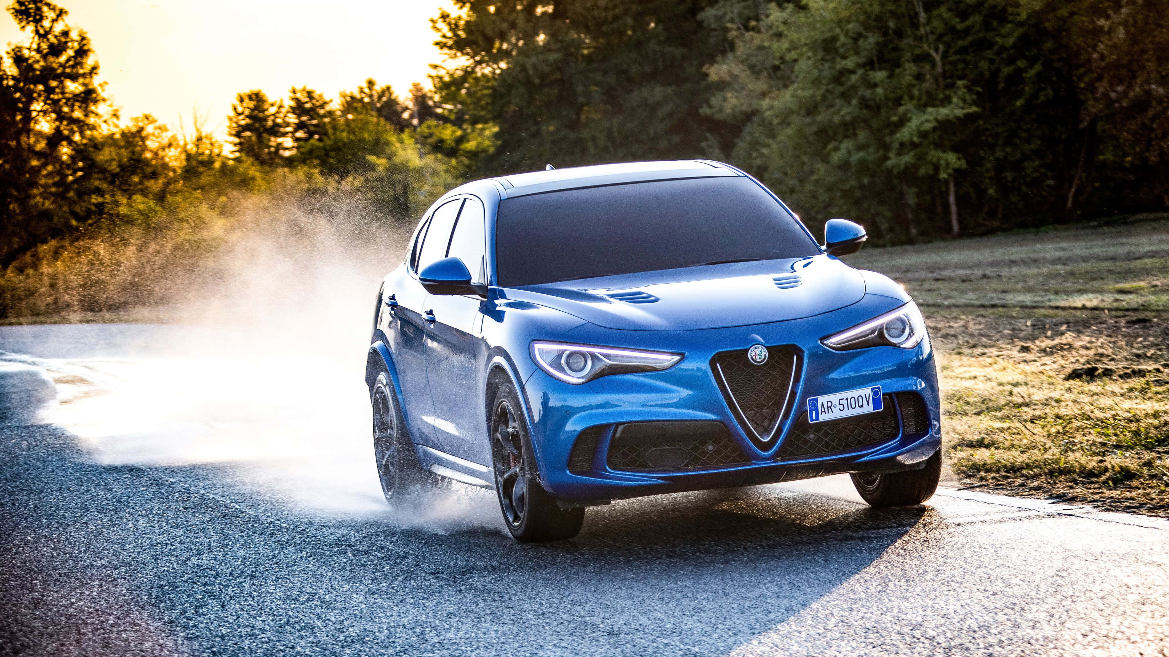 Alfa Romeo Stelvio, vibrant blue, wet forest road, 4K Desktop Wallpaper