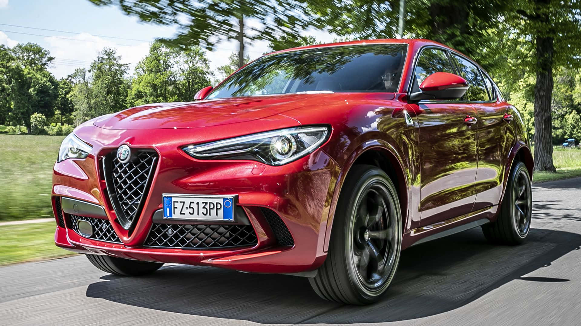 Alfa Romeo Stelvio, glossy red, tree-lined road, Full HD Desktop Wallpaper