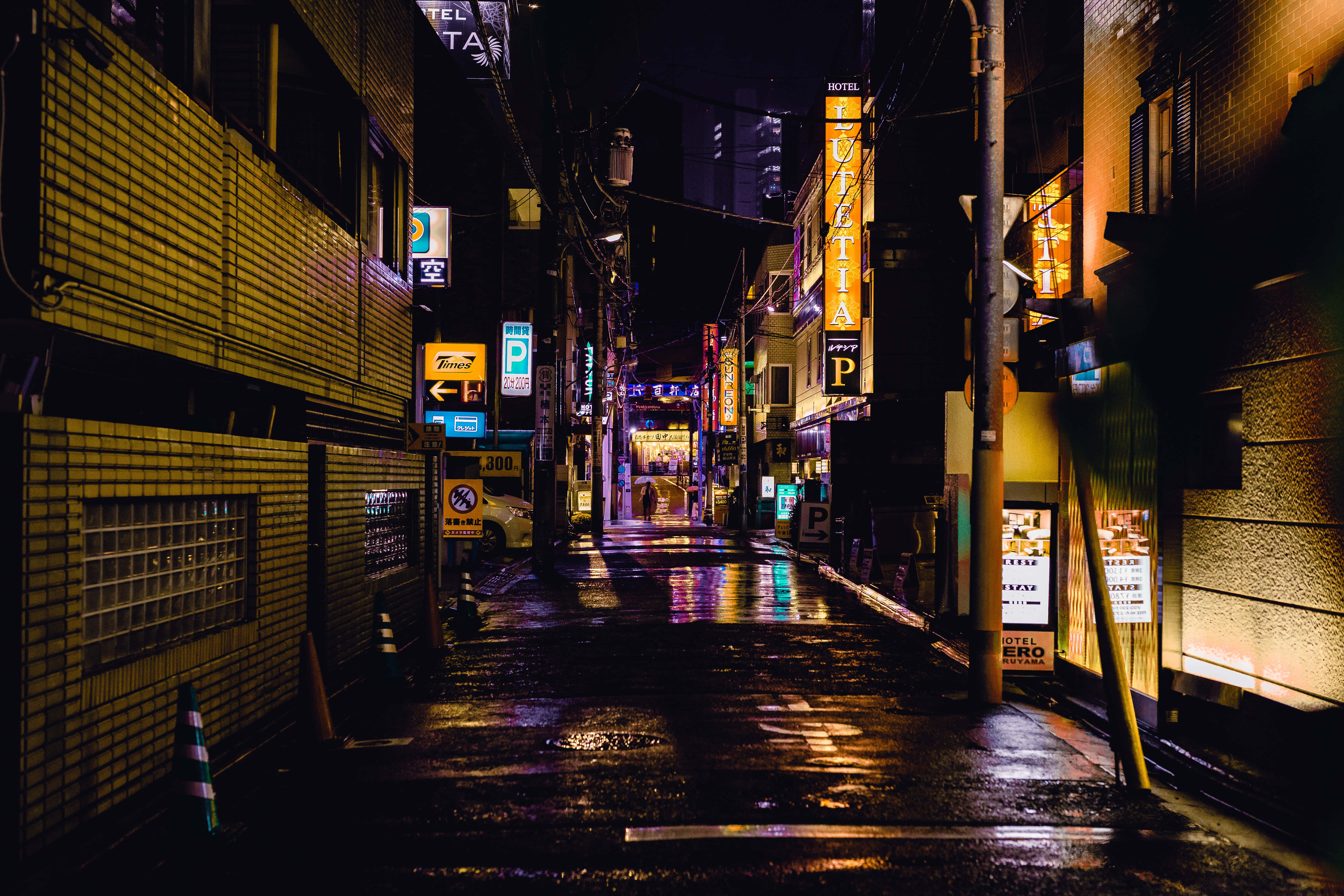 neon-lit alleyway, rain-slicked, wet pavement, 5K Desktop Wallpaper
