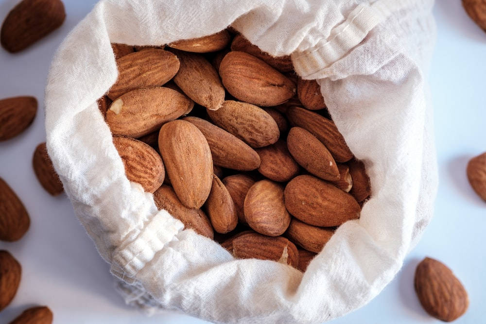 organic whole almond nuts, white cloth sack, brown almonds, SD Desktop Wallpaper