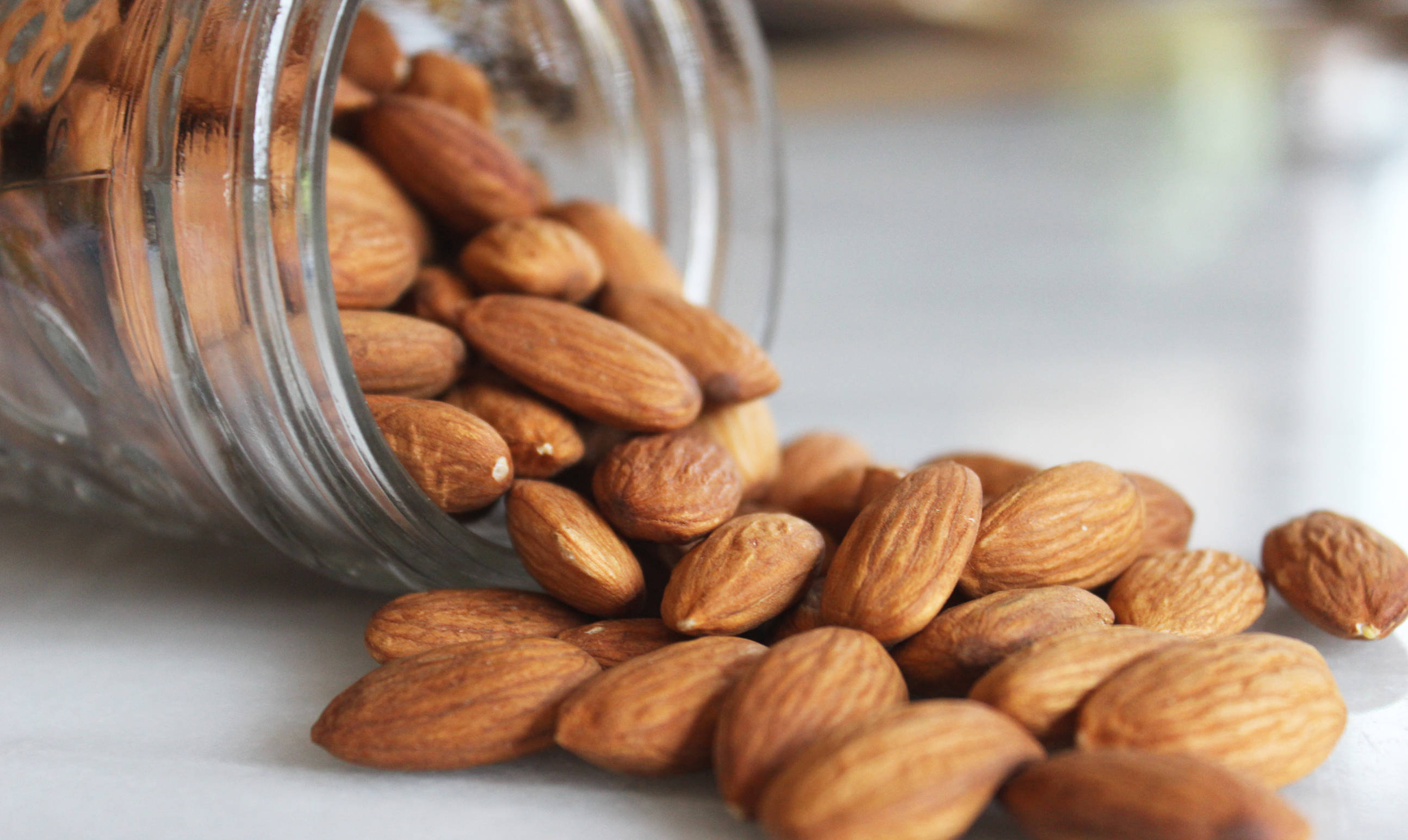 splendid organic almond nuts, clear glass jar, textured brown almonds, 2K Desktop Wallpaper