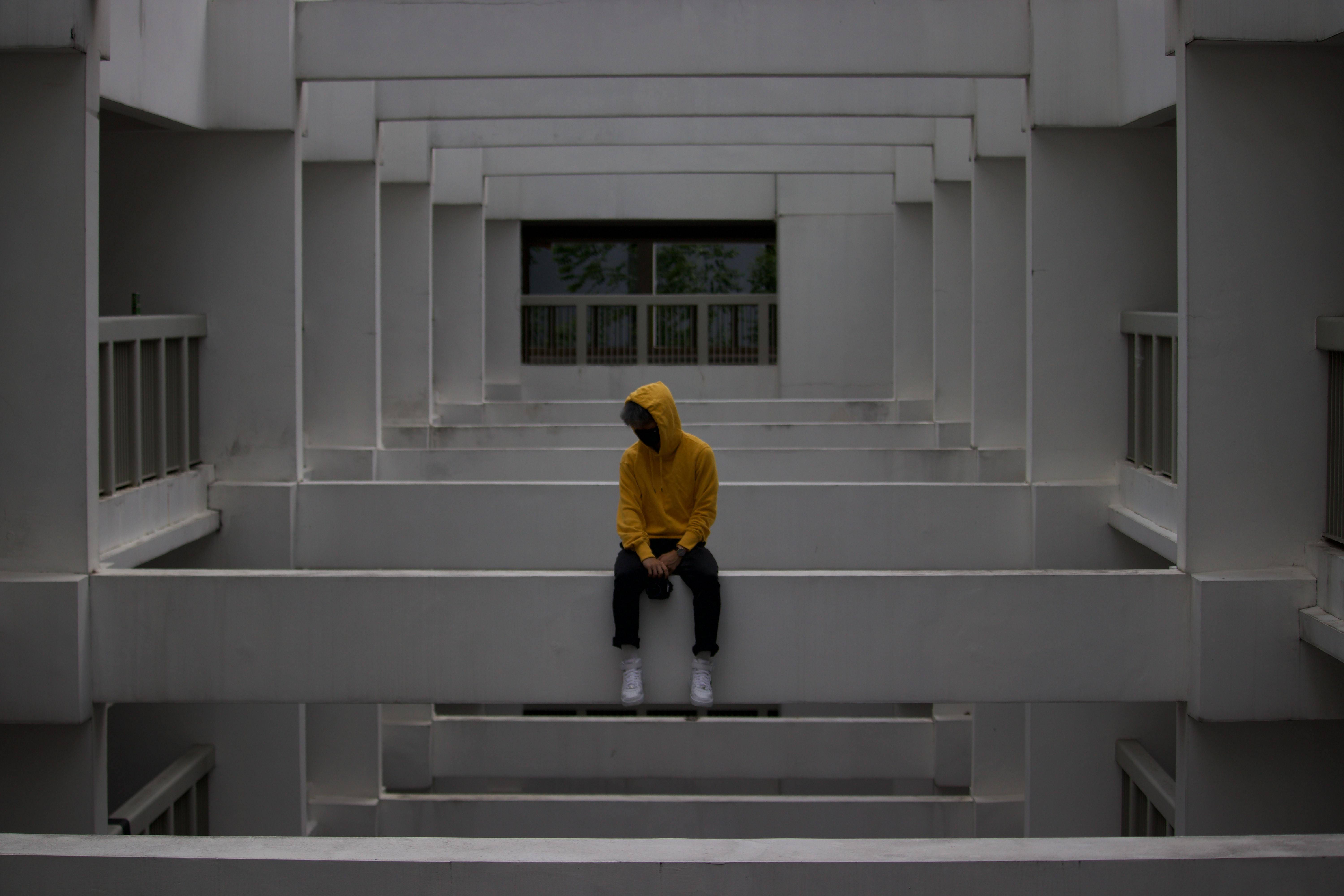bright yellow hoodie, stark white concrete steps, geometrically complex modern building, 5K Desktop Wallpaper