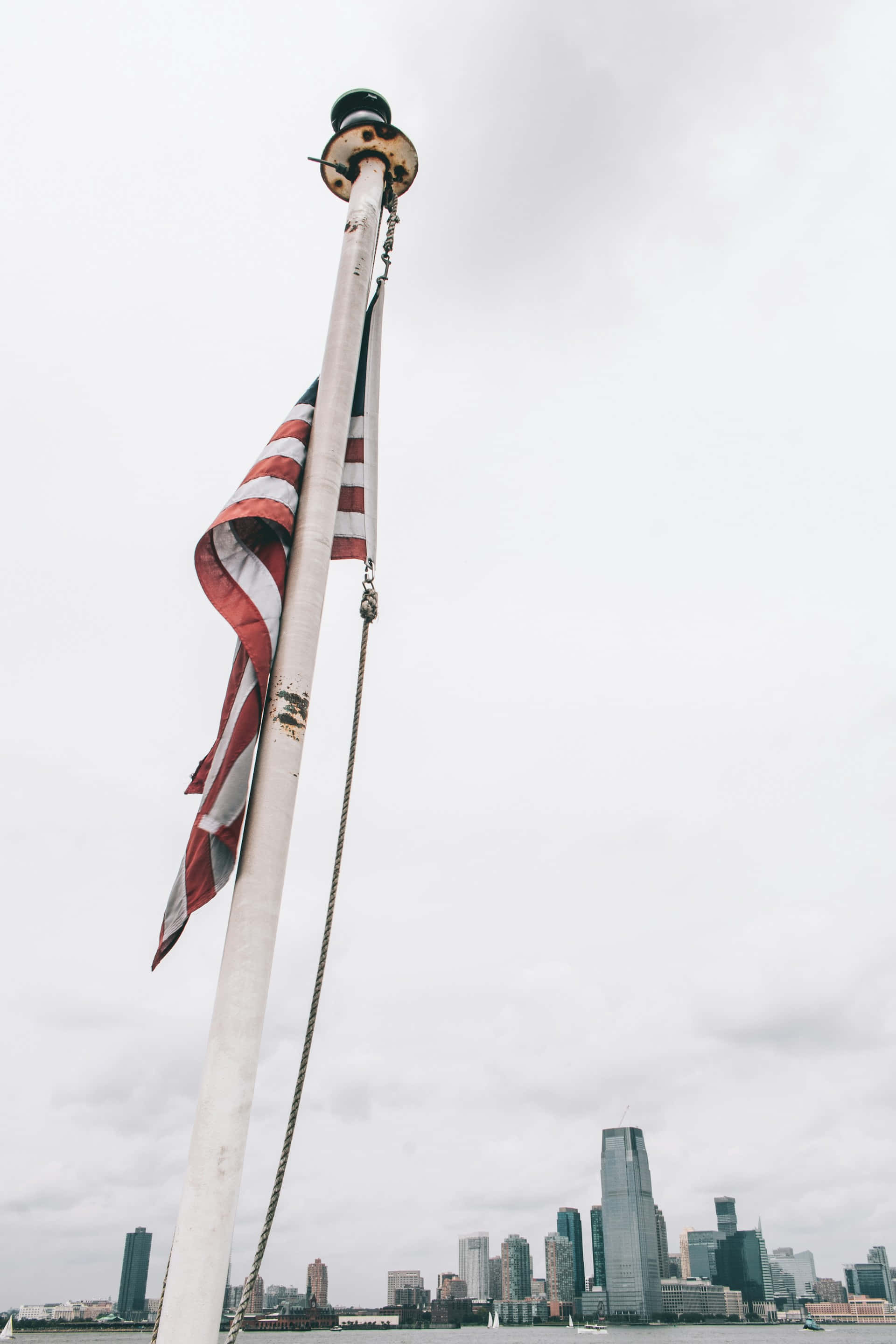 American Flag, weathered pole, cloudy sky, 2K Phone Wallpaper