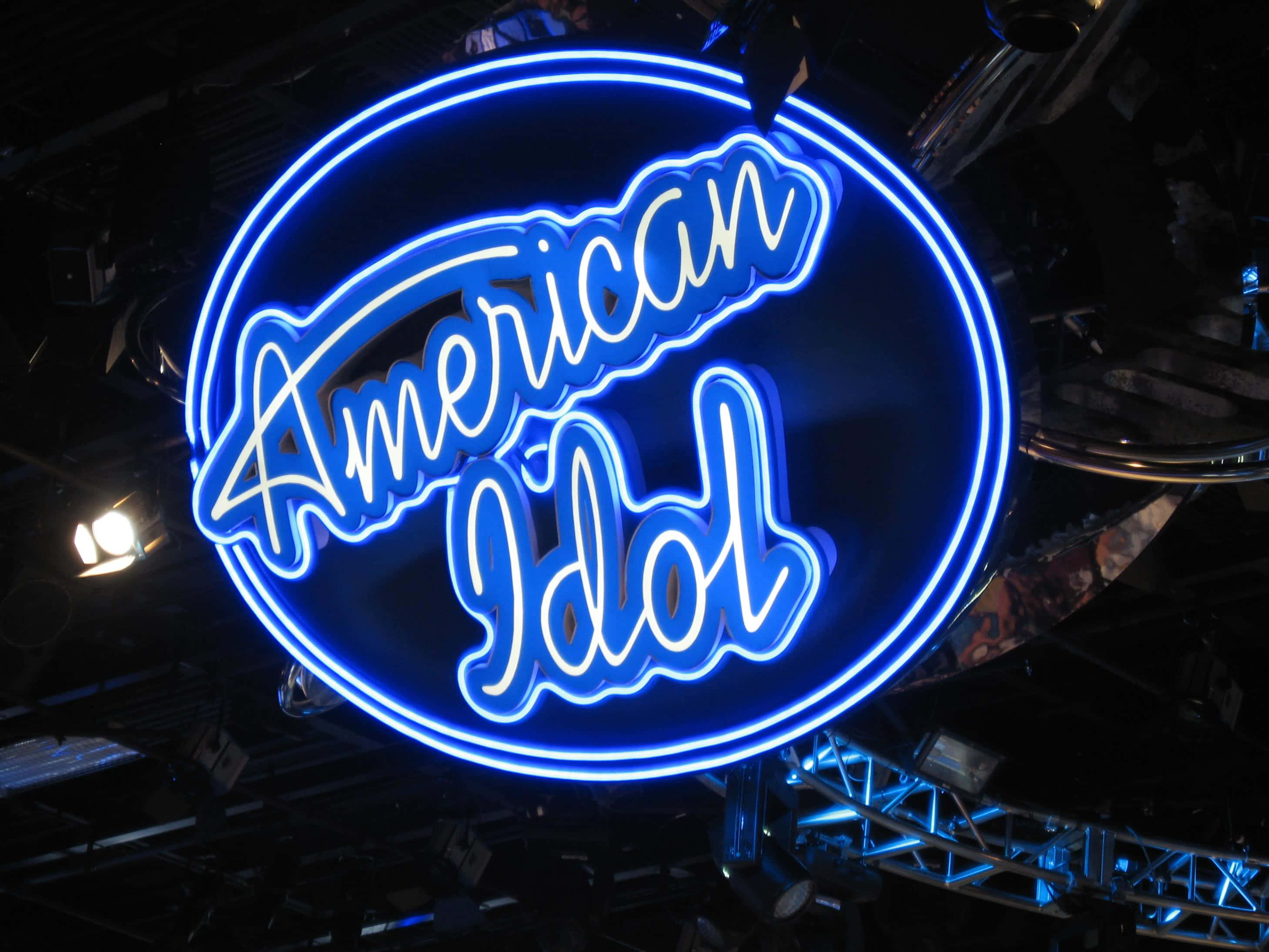 American Idol, glowing blue neon sign, dark stage backdrop, 2K Desktop Wallpaper