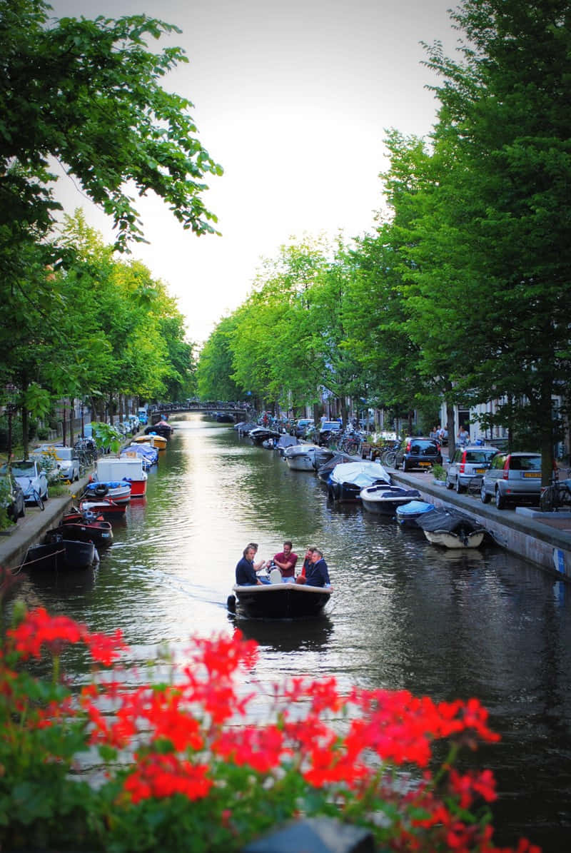 Amsterdam Spring, canal scene, people in a boat, SD Phone Wallpaper