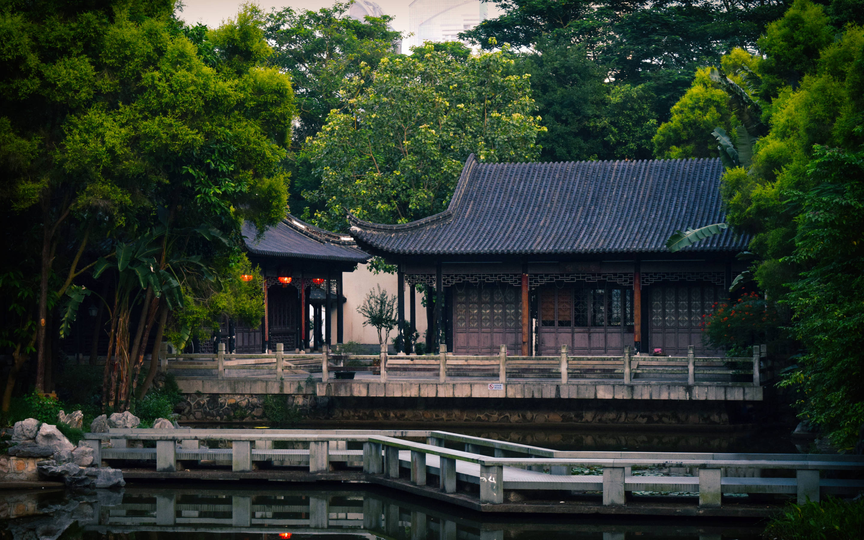 Traditional wooden pavilion, curved roof, calm pond, 2K Desktop Wallpaper