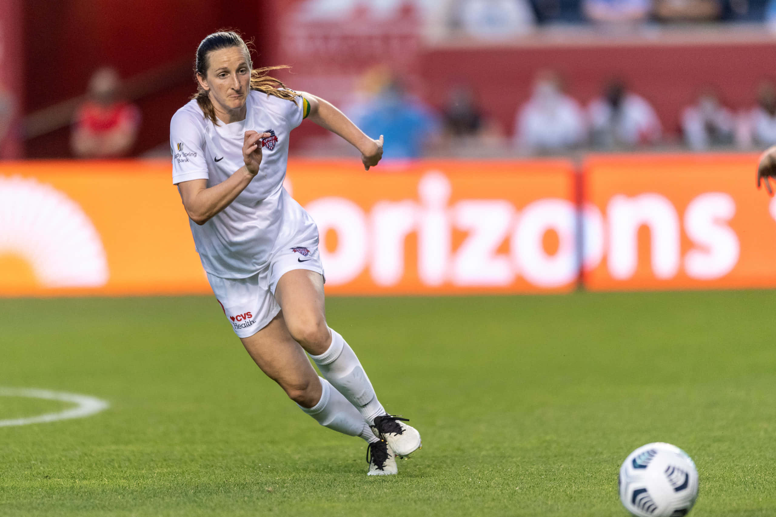 Andi Sullivan, white uniform, vibrant green field, 2K Desktop Wallpaper
