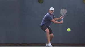 Andy Roddick, bright yellow ball, dark gray wall, SD Desktop Wallpaper
