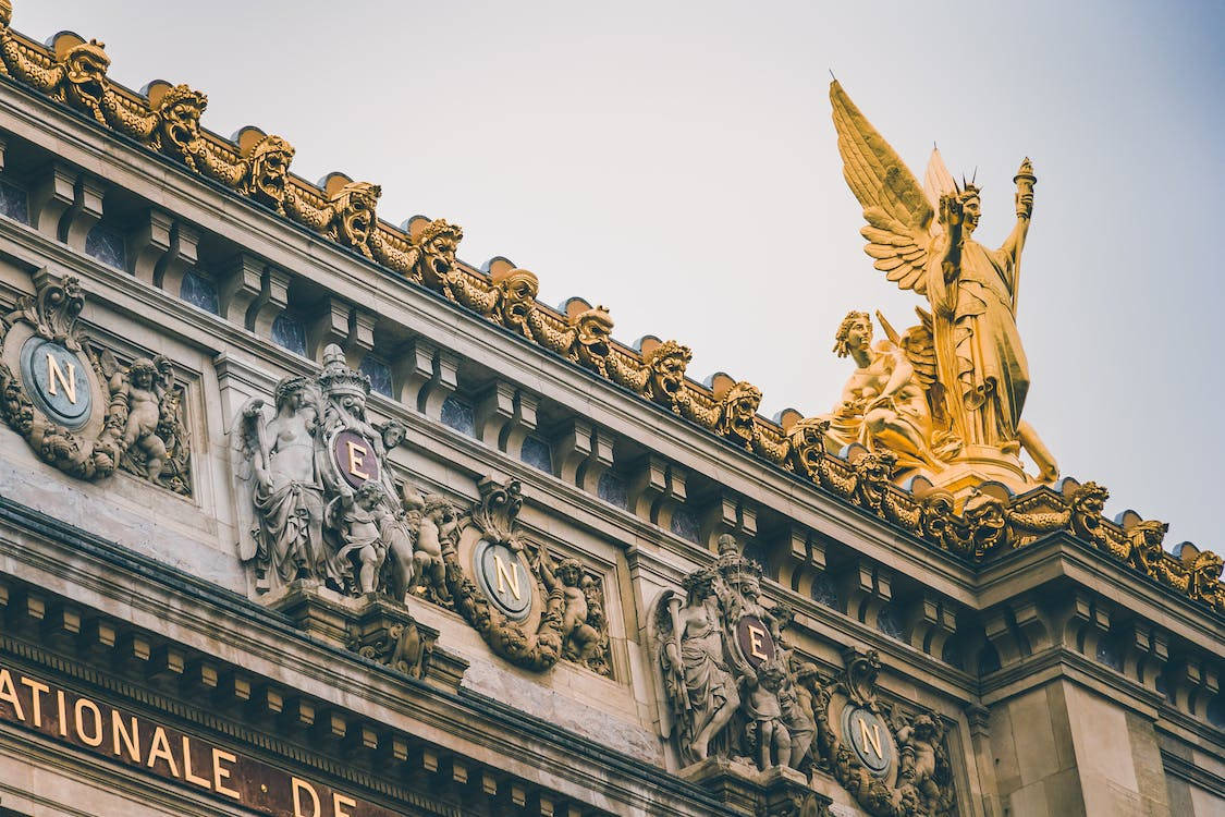 golden angel statue, ornate stone building facade, gilded gargoyles, SD Desktop Wallpaper