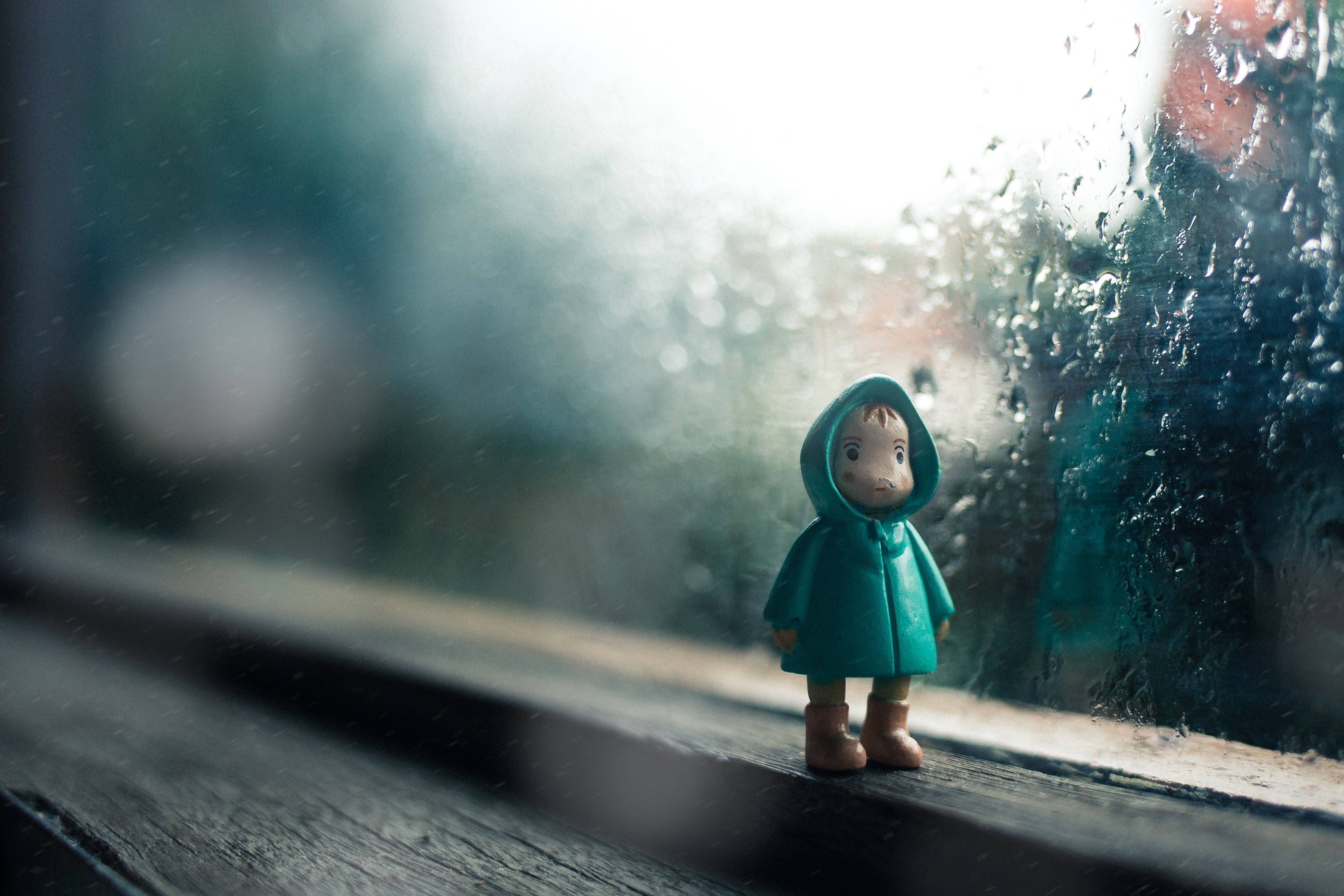 Tiny Kid Figure, teal raincoat, windowsill, 4K Desktop Wallpaper