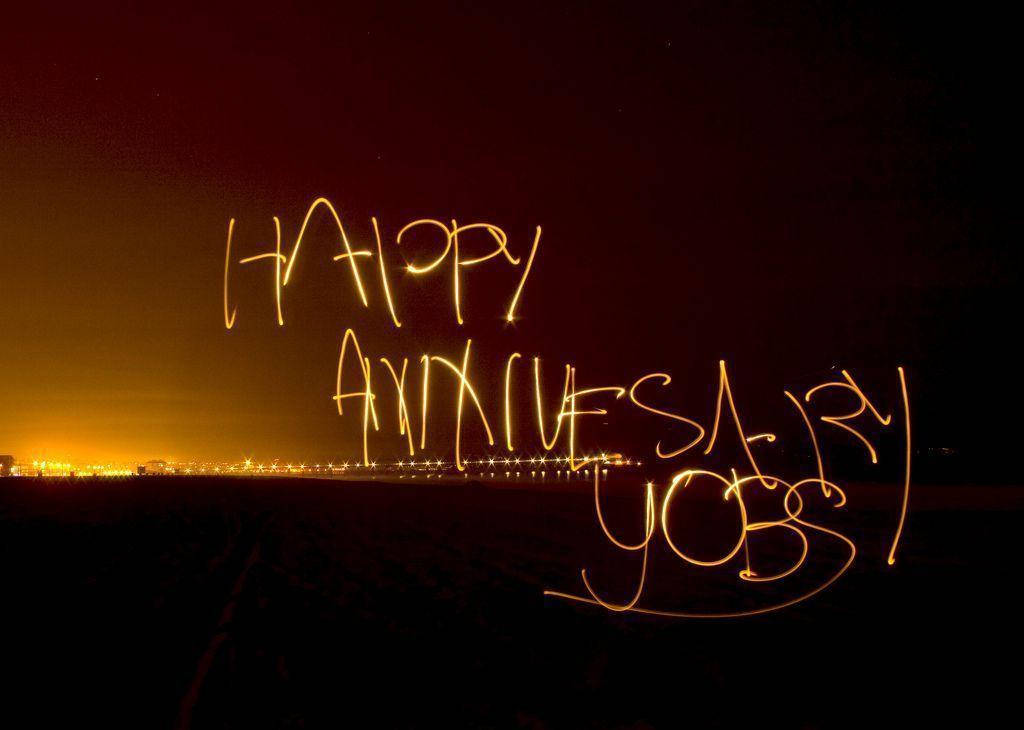 Happy Anniversary, golden light-painted text, dark night sky, SD Desktop Wallpaper
