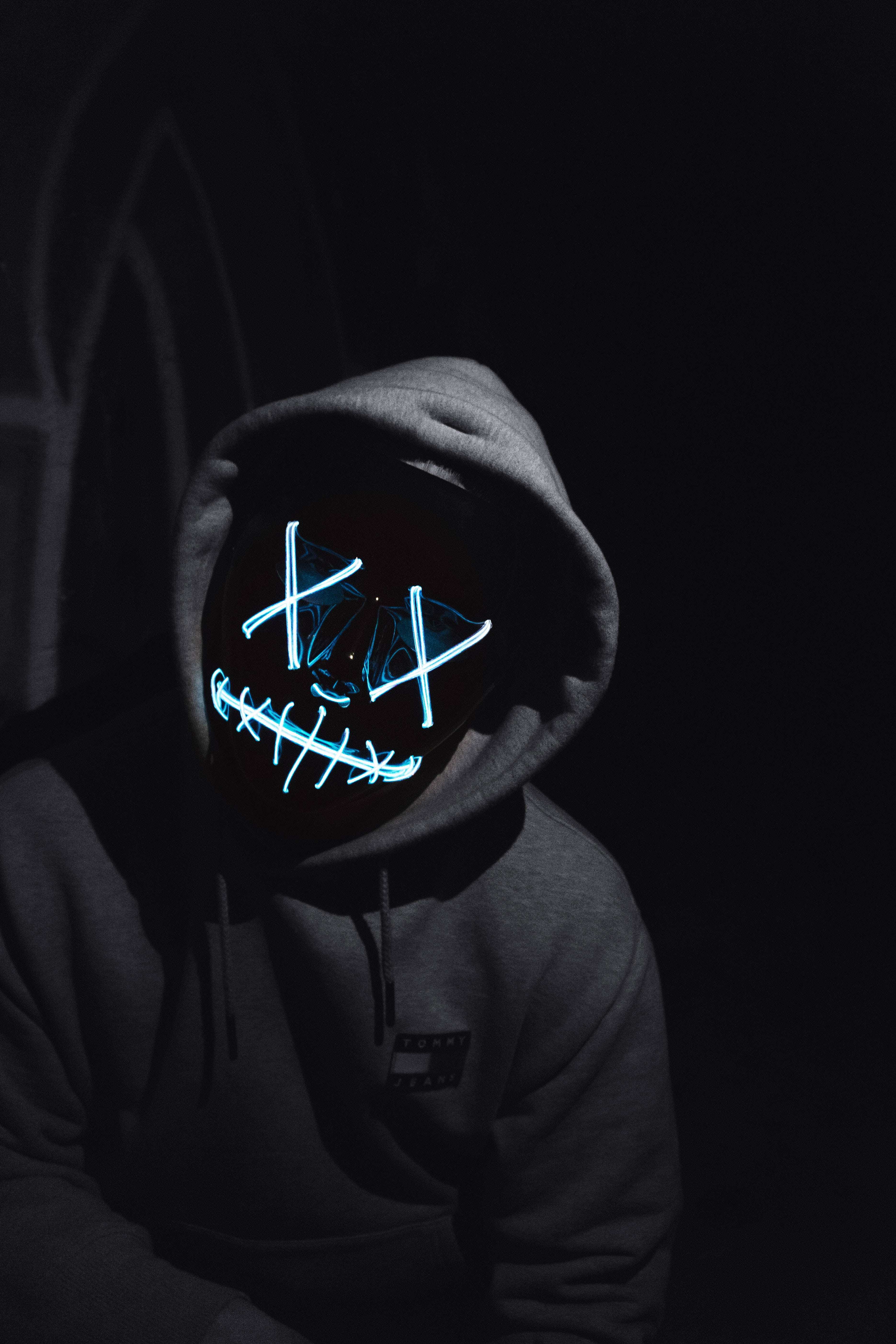anonymous guy, dark hoodie, glowing blue LED mask, 5K Phone Wallpaper