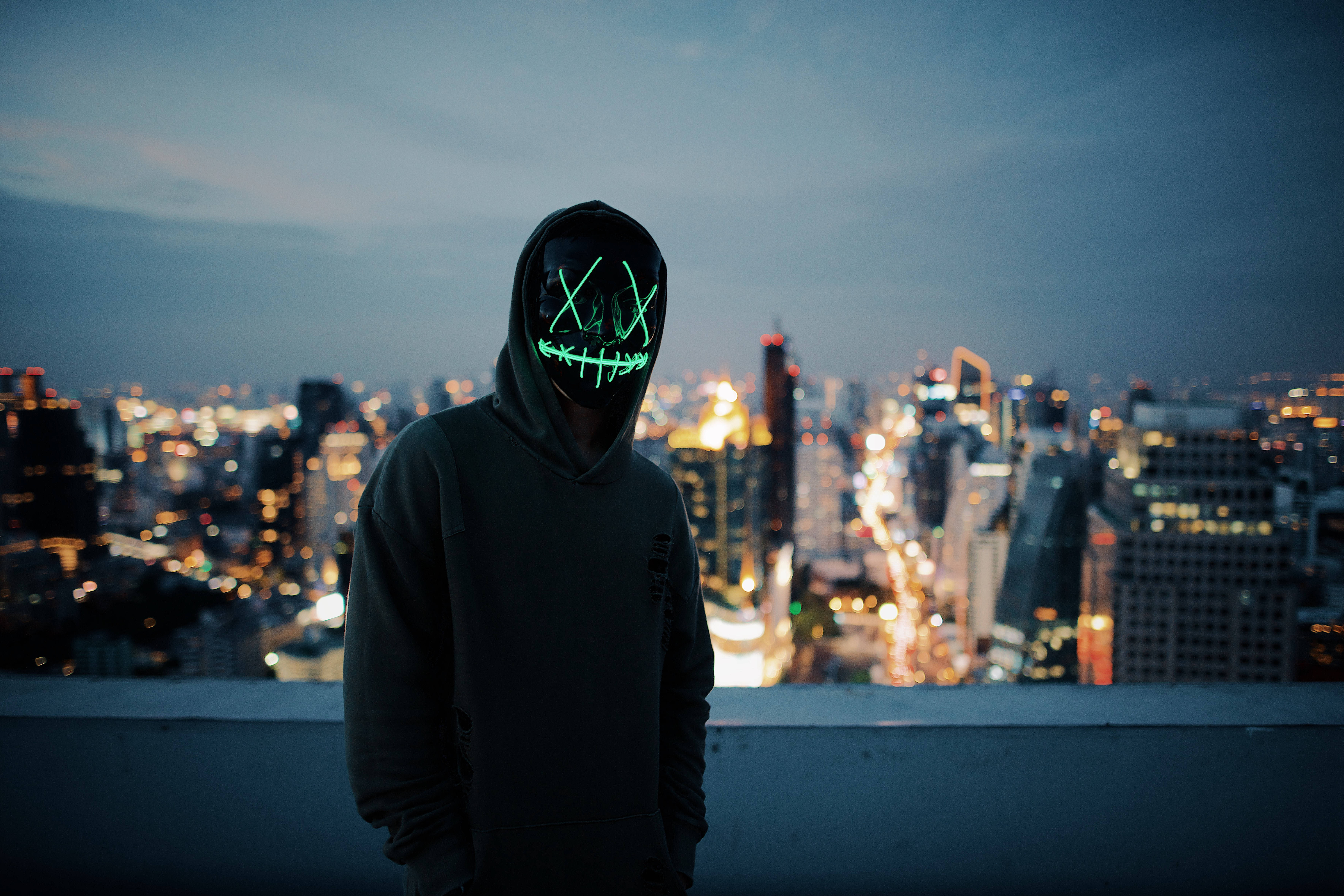 Anonymous, glowing green LED mask, rooftop, 5K Desktop Wallpaper